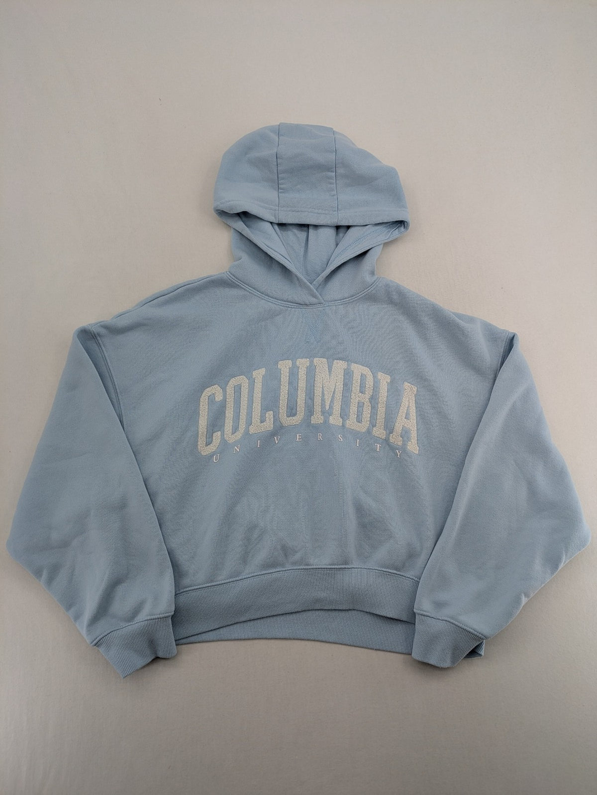 Columbia University blue hoodie with large "Columbia University" text on chest.