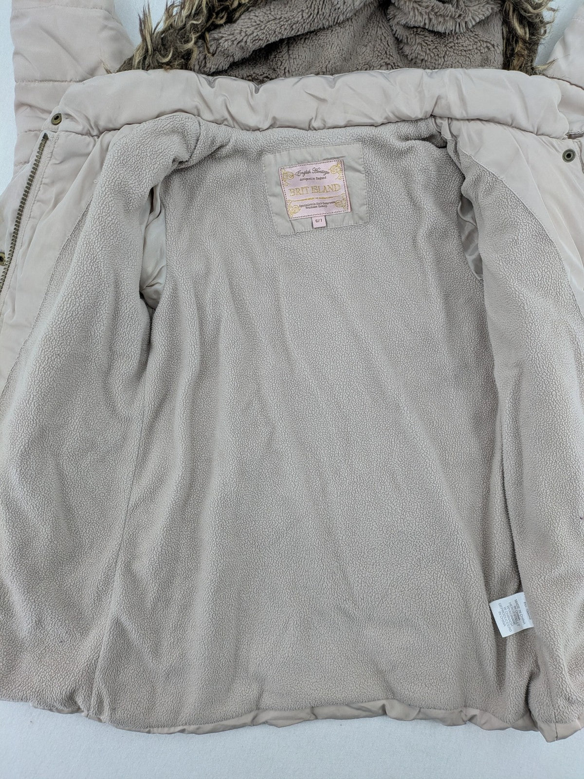 Brit Island beige puffer coat with fleece lining and faux fur hood detail.