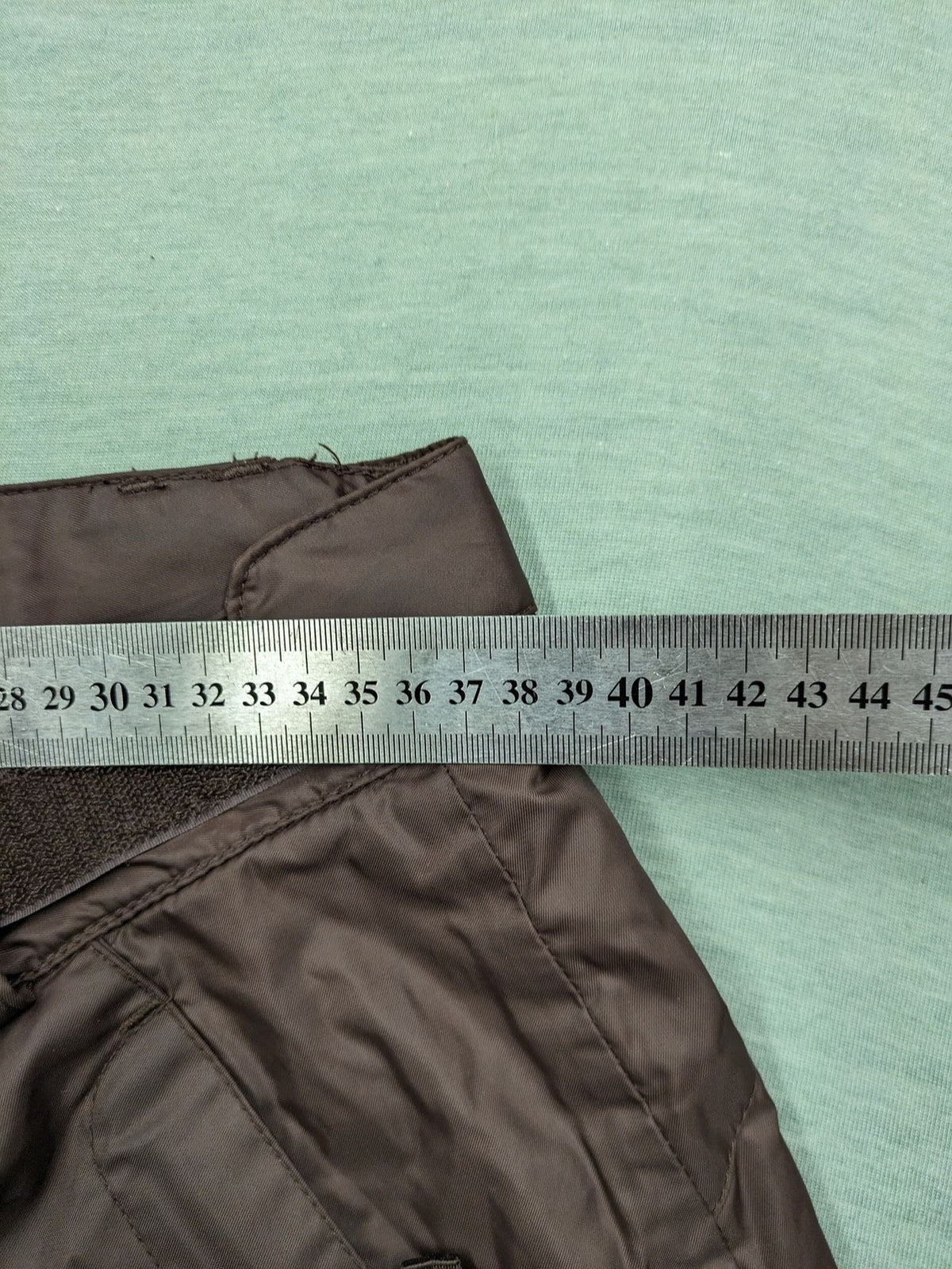 Thinsulate black and blue ski jumpsuit with hood and zippered pockets.