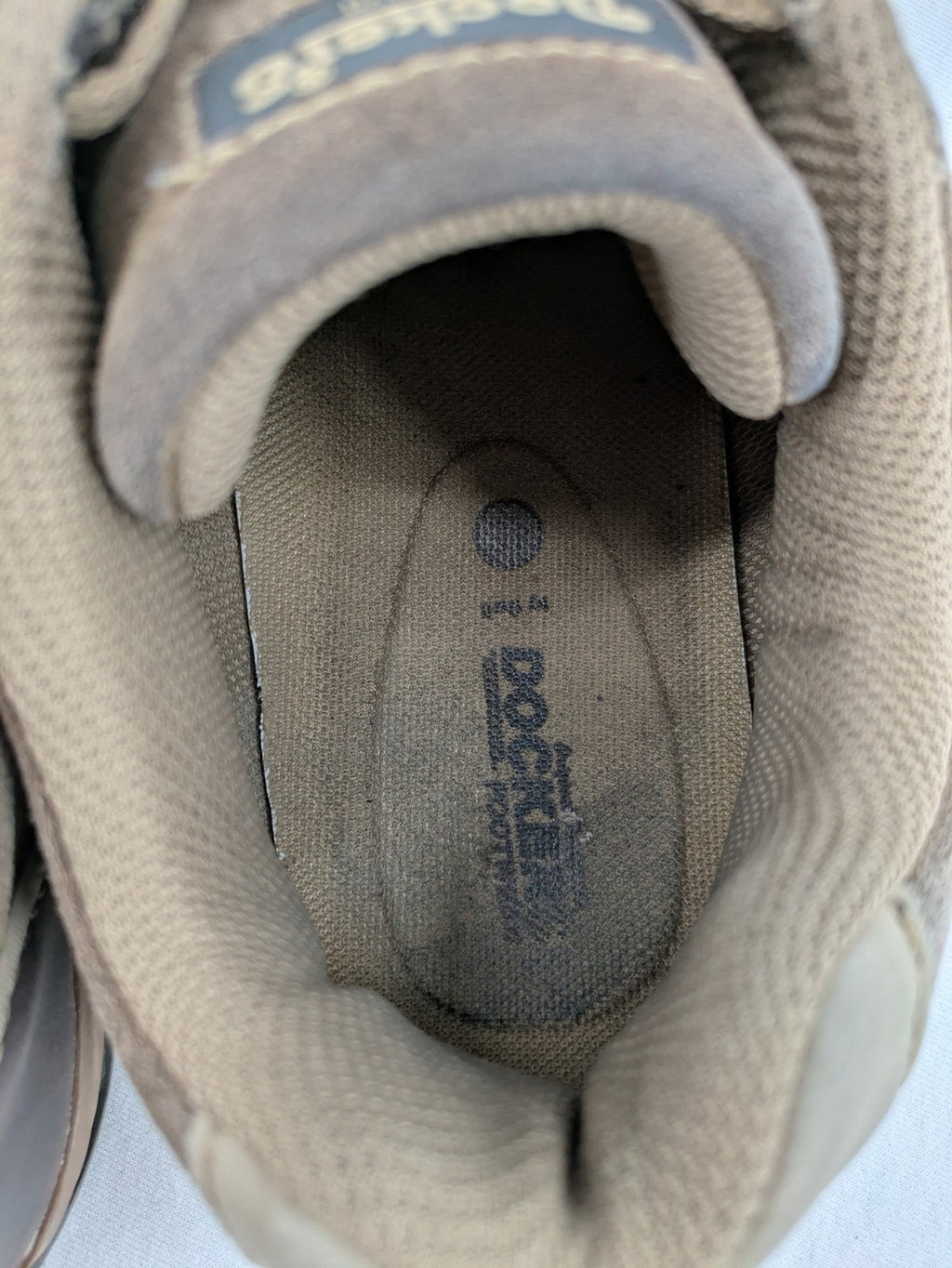 Dockers brown sneakers with subtle light brown and blue accents, lace-up design.
