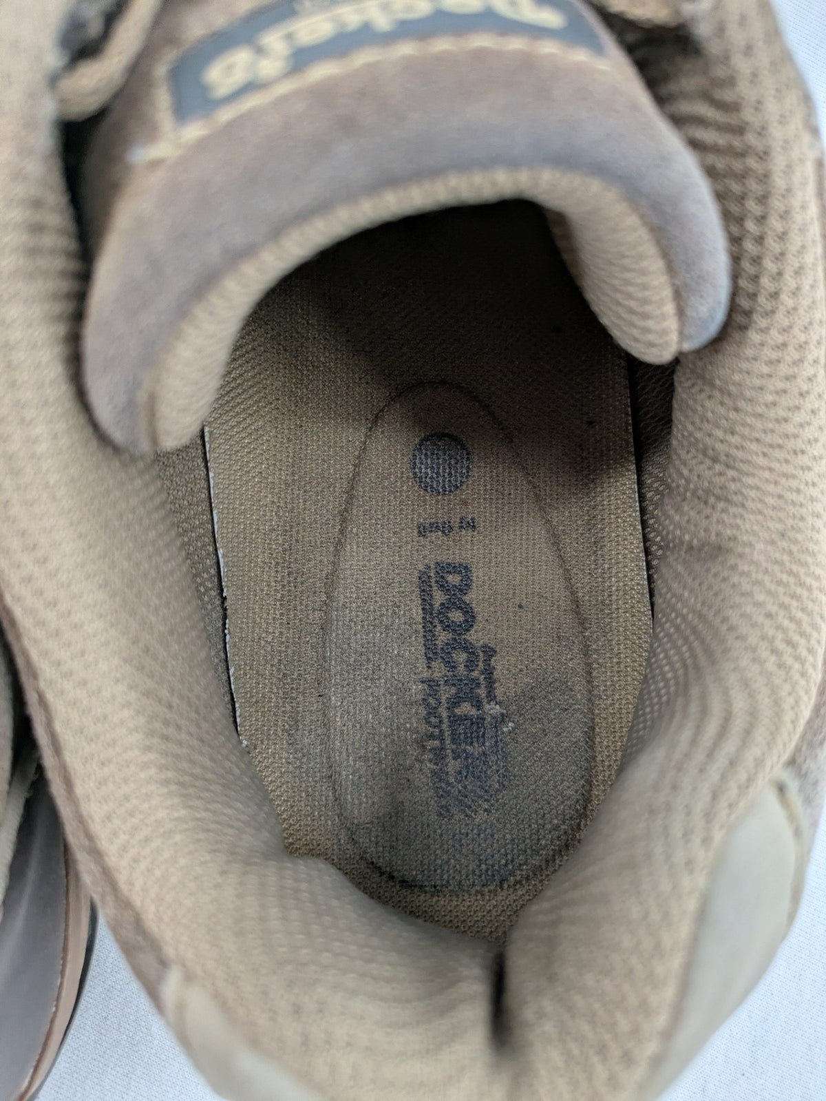 Dockers brown sneakers with subtle light brown and blue accents, lace-up design.