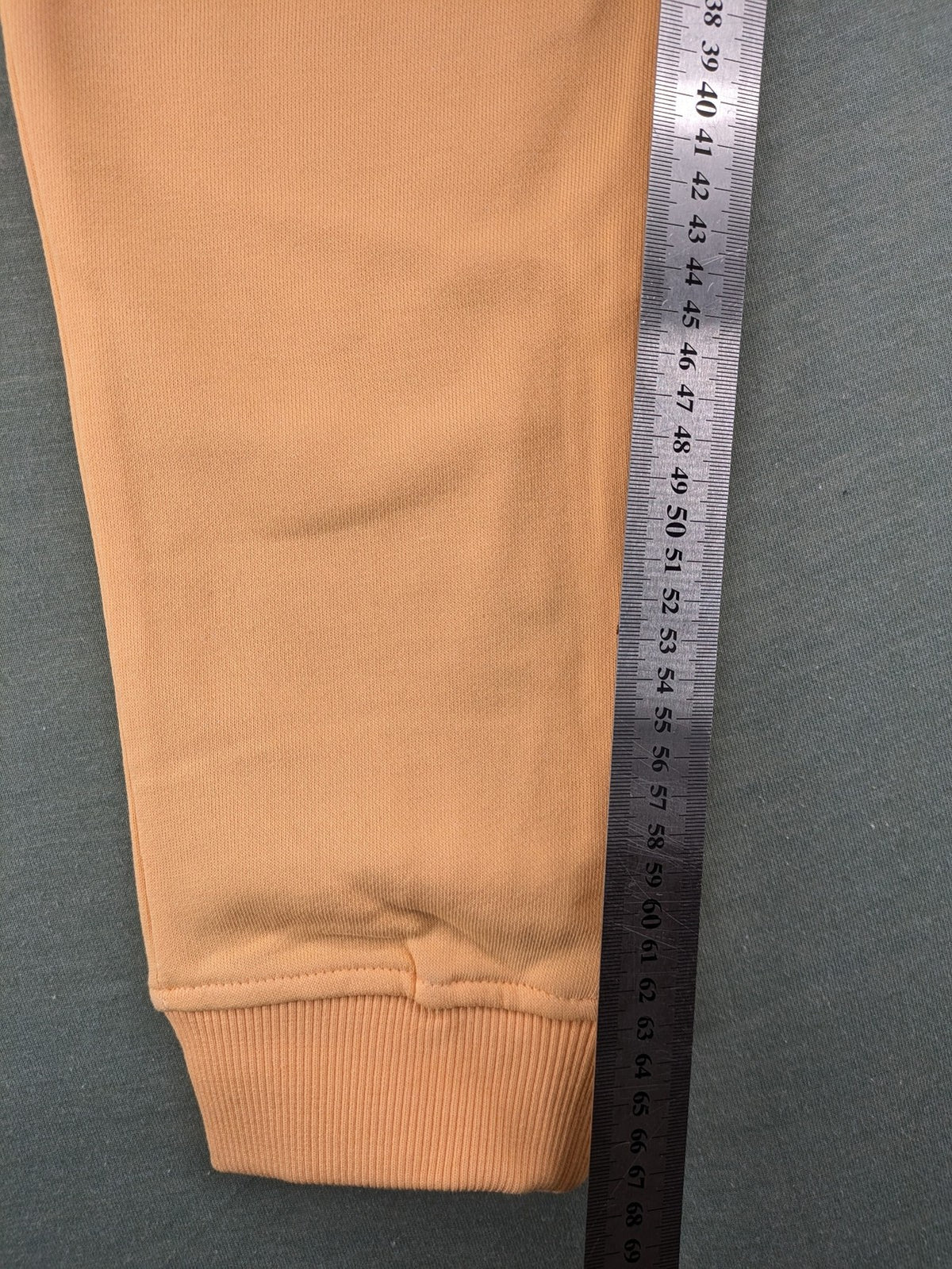 U.S. Polo Assn. orange sweatpants slim fit with sequin USPA logo on leg.