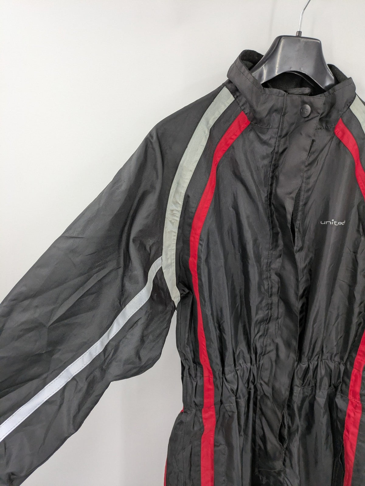 Unitech black rain suit with red reflective stripes and full zipper, size M.
