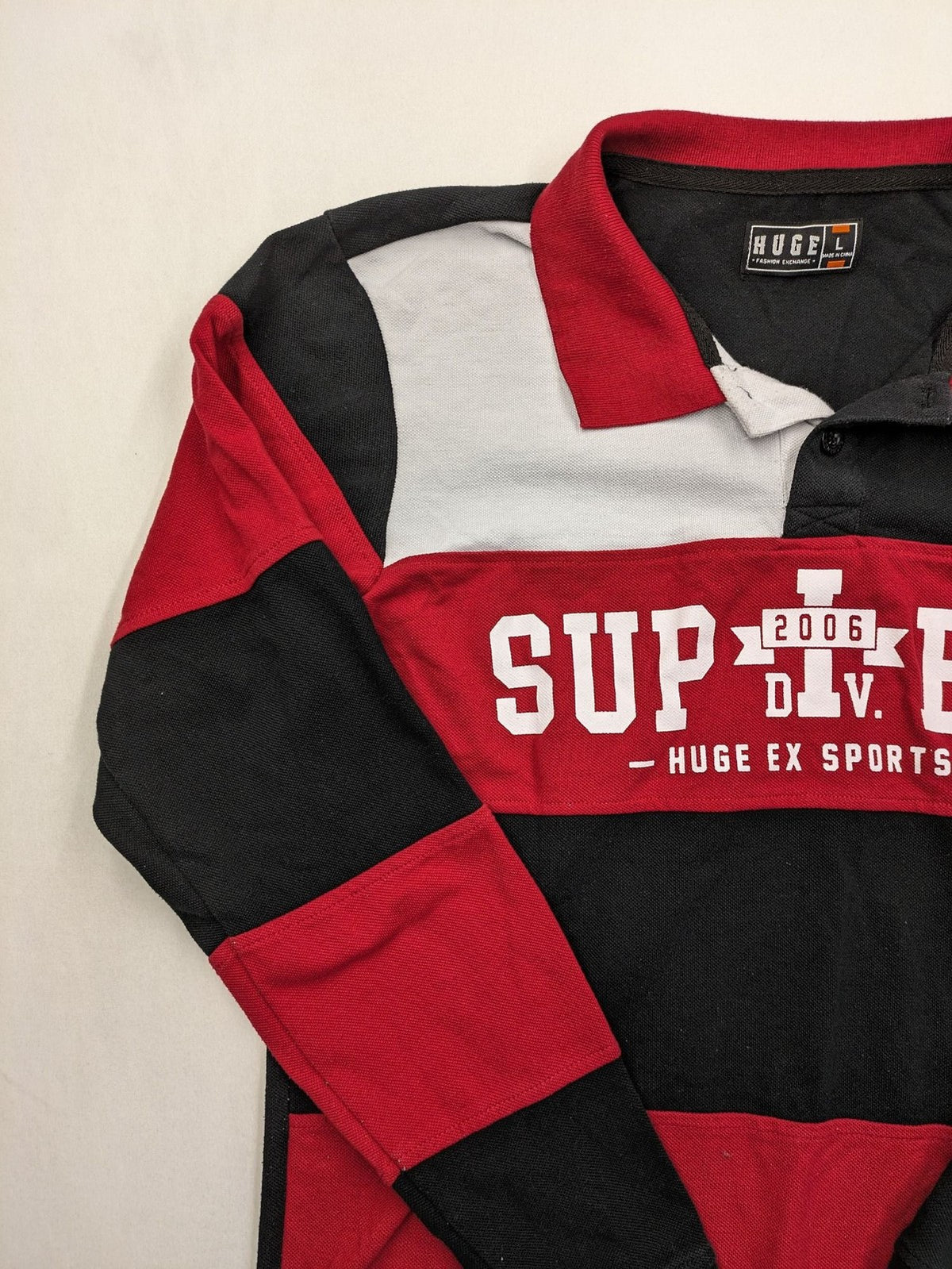 Huge Fashion Exchange rugby polo shirt red and black striped with "SUPERB" graphic.