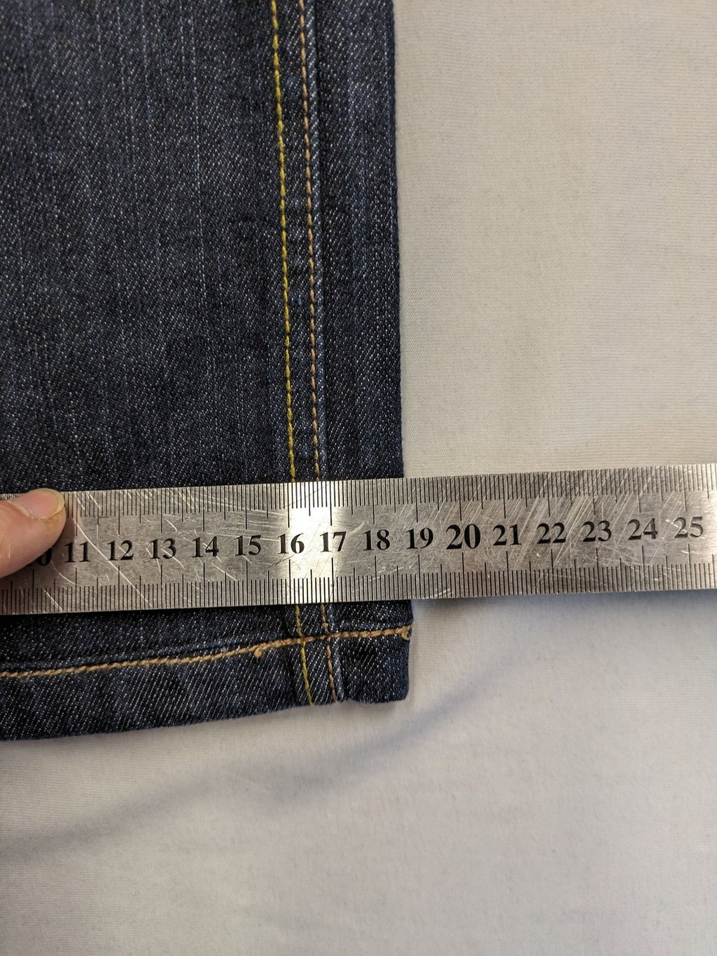 Furore blue straight jeans with yellow contrast stitching and zipper details.
