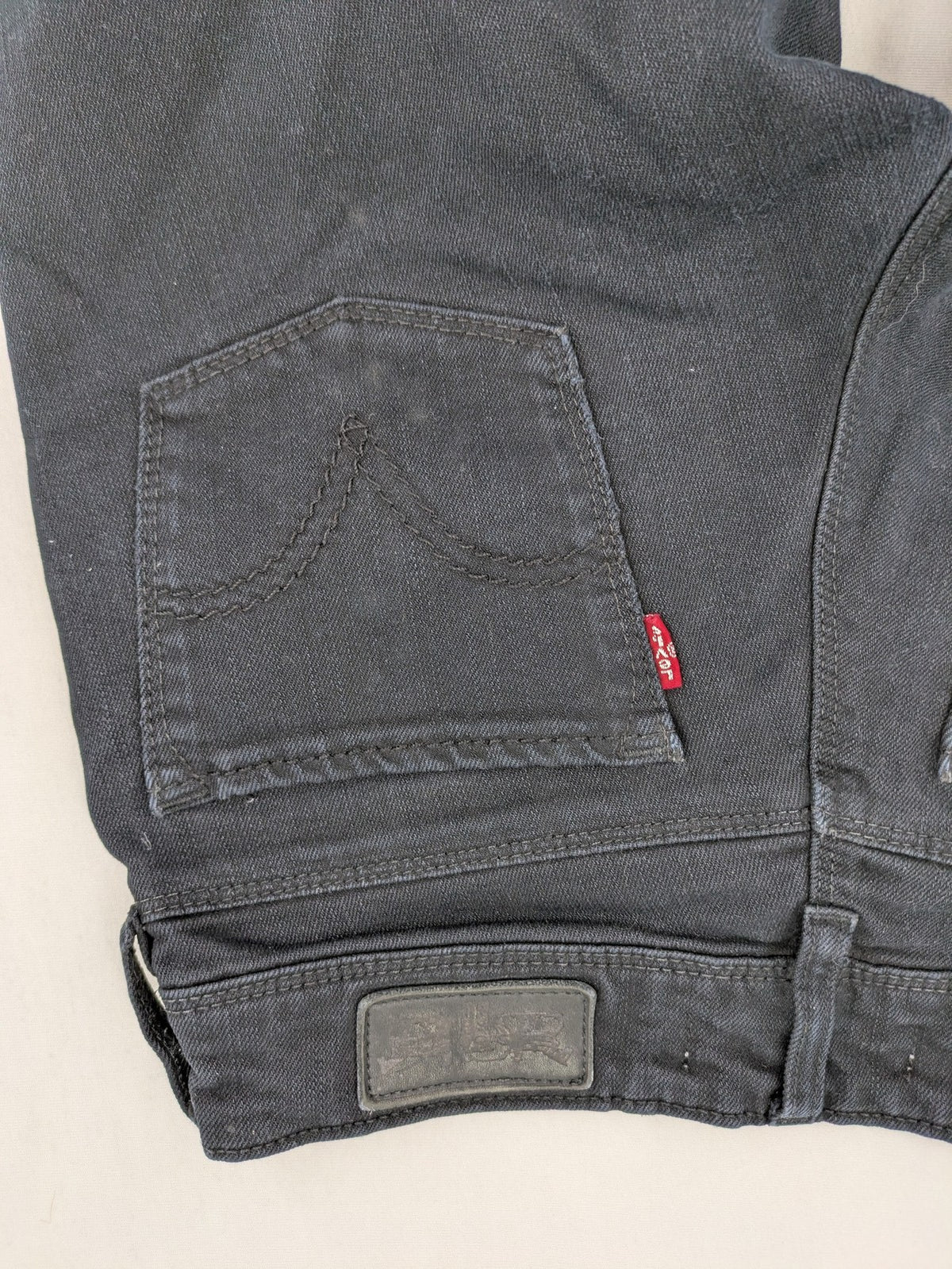 Levi's black slim fit jeans with classic 5-pocket design and zipper fly.