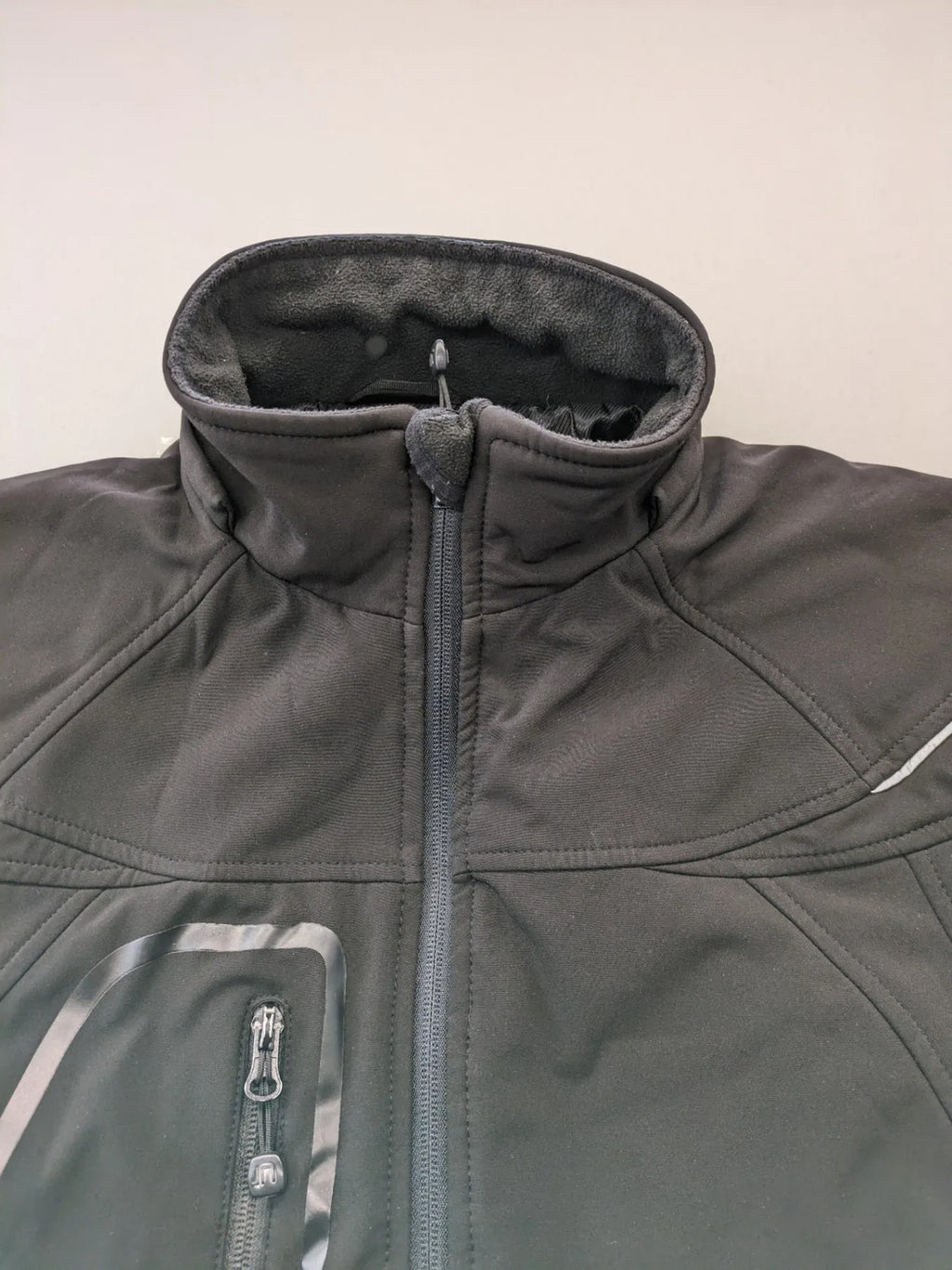 James & Nicholson grey softshell jacket with fleece lining and multiple zip pockets.