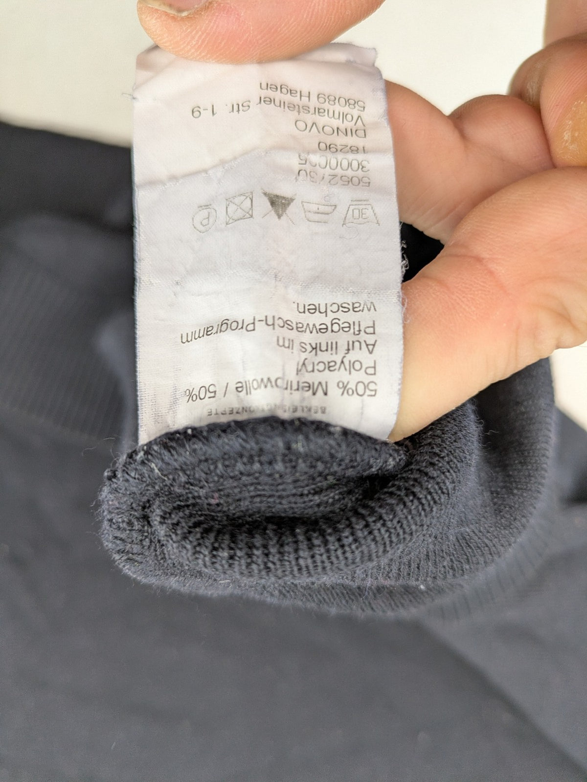 Dinovo grey knit jumper with ribbed roll neck and cuffs, made from merino wool blend.