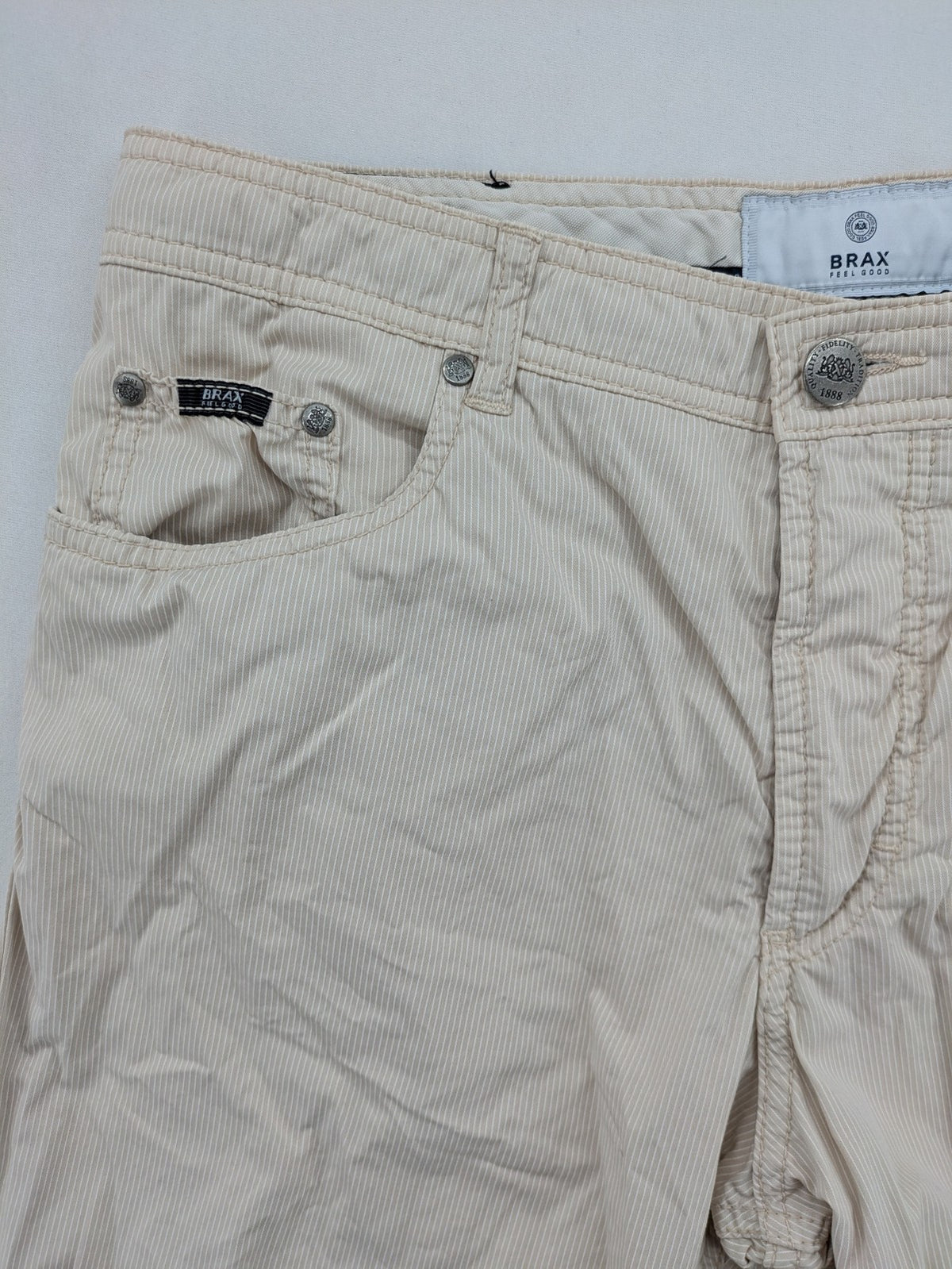 BRAX beige striped pants with logo, made from comfortable stretch cotton blend.