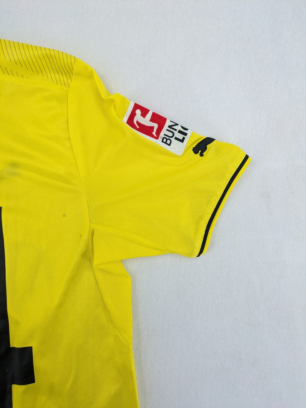 Borussia Dortmund black and yellow soccer uniform with DFB Pokal 2014 patch and Puma logo.