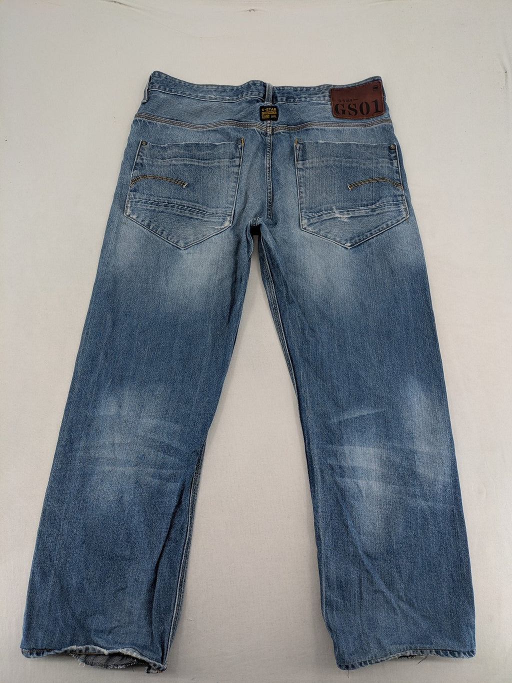 G-Star Raw blue straight jeans with distressed details and classic button fly.