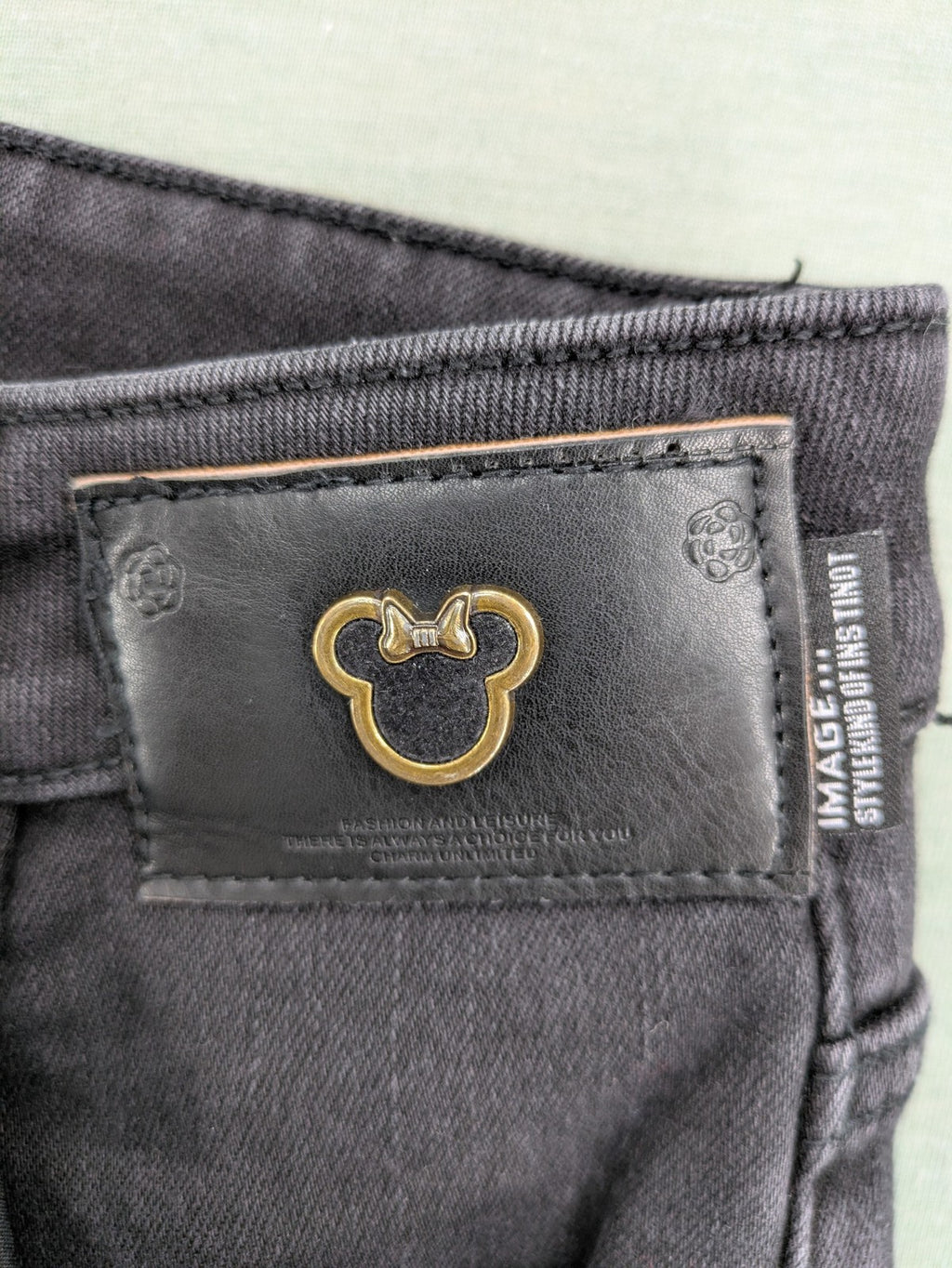 Disney black straight jeans with Minnie Mouse detail, cropped length, stretchy cotton blend.