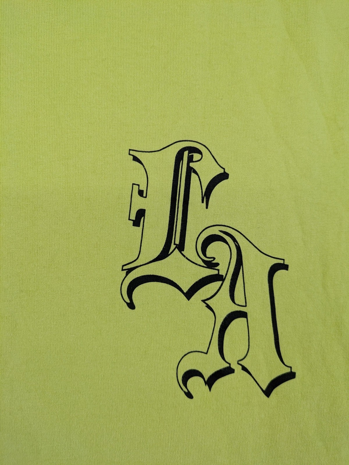 Primark yellow band t-shirt featuring Gothic LA graphic print and "PRESENT" patch.