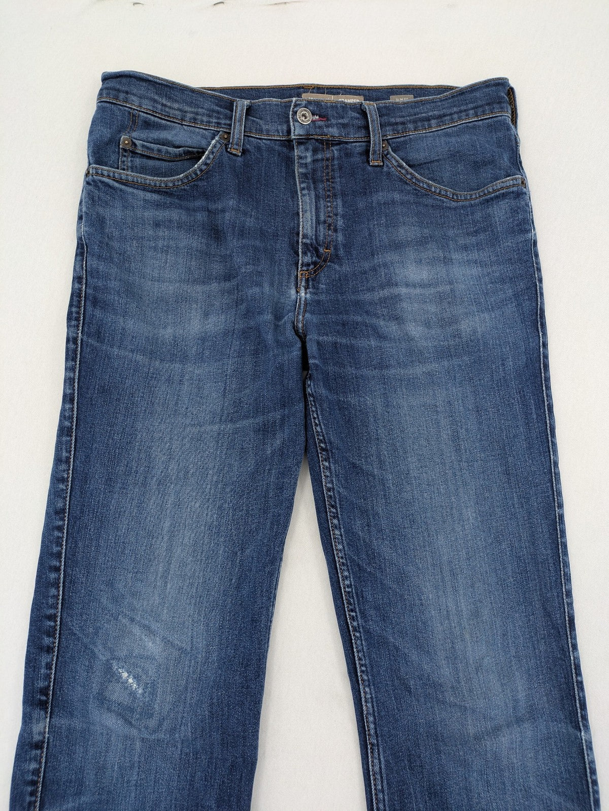 Mustang blue tapered jeans with slim fit, medium rise, and classic denim texture.