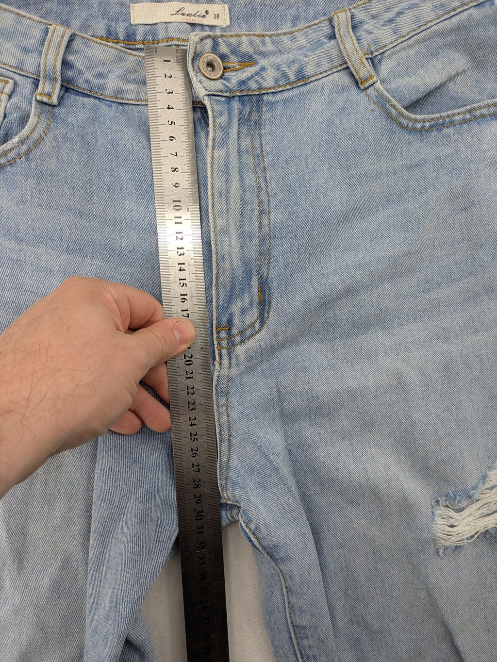 Laulia blue wide leg jeans with distressed knee rips and high waist design.