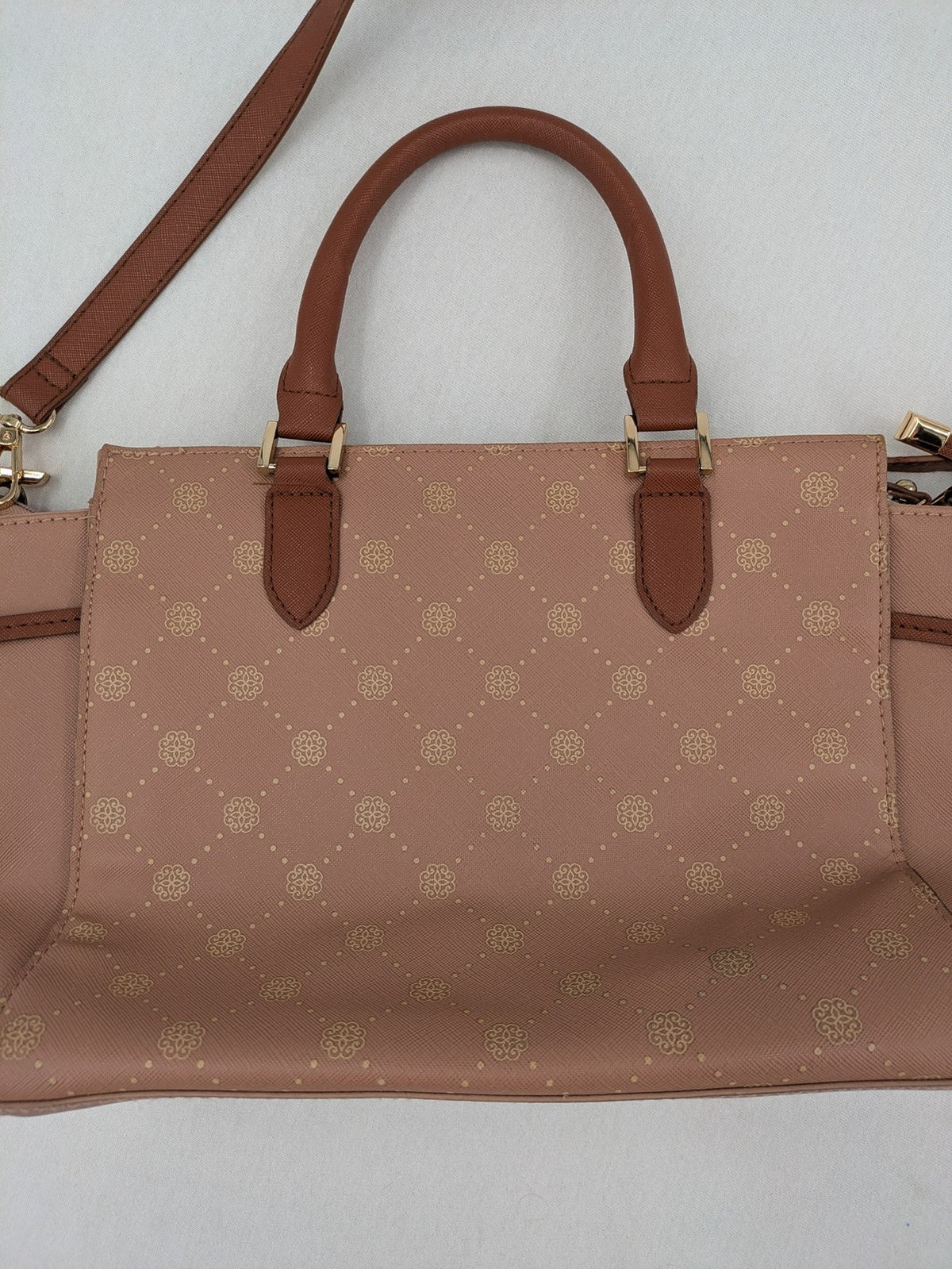 Catwalk gold handbag with pink and brown monogram pattern, adjustable shoulder strap.
