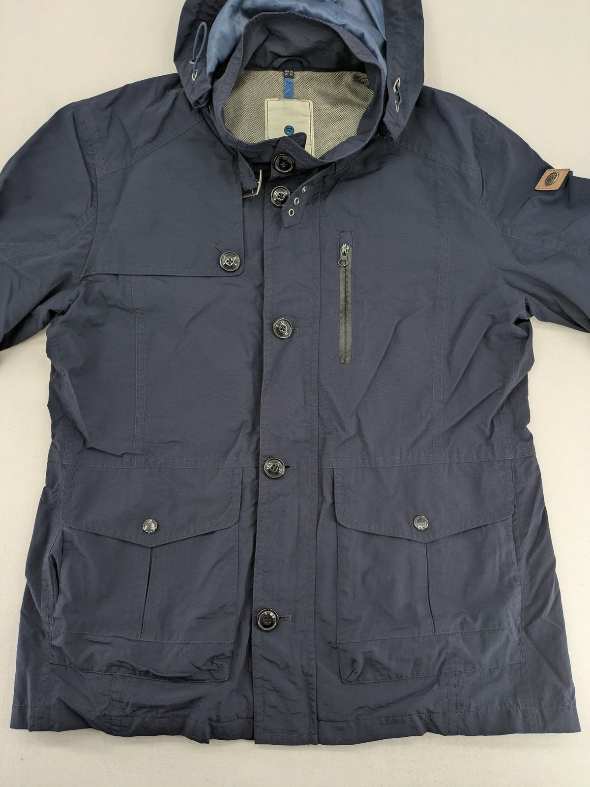 Reset navy parka jacket windproof with adjustable hood and zippered chest pocket.