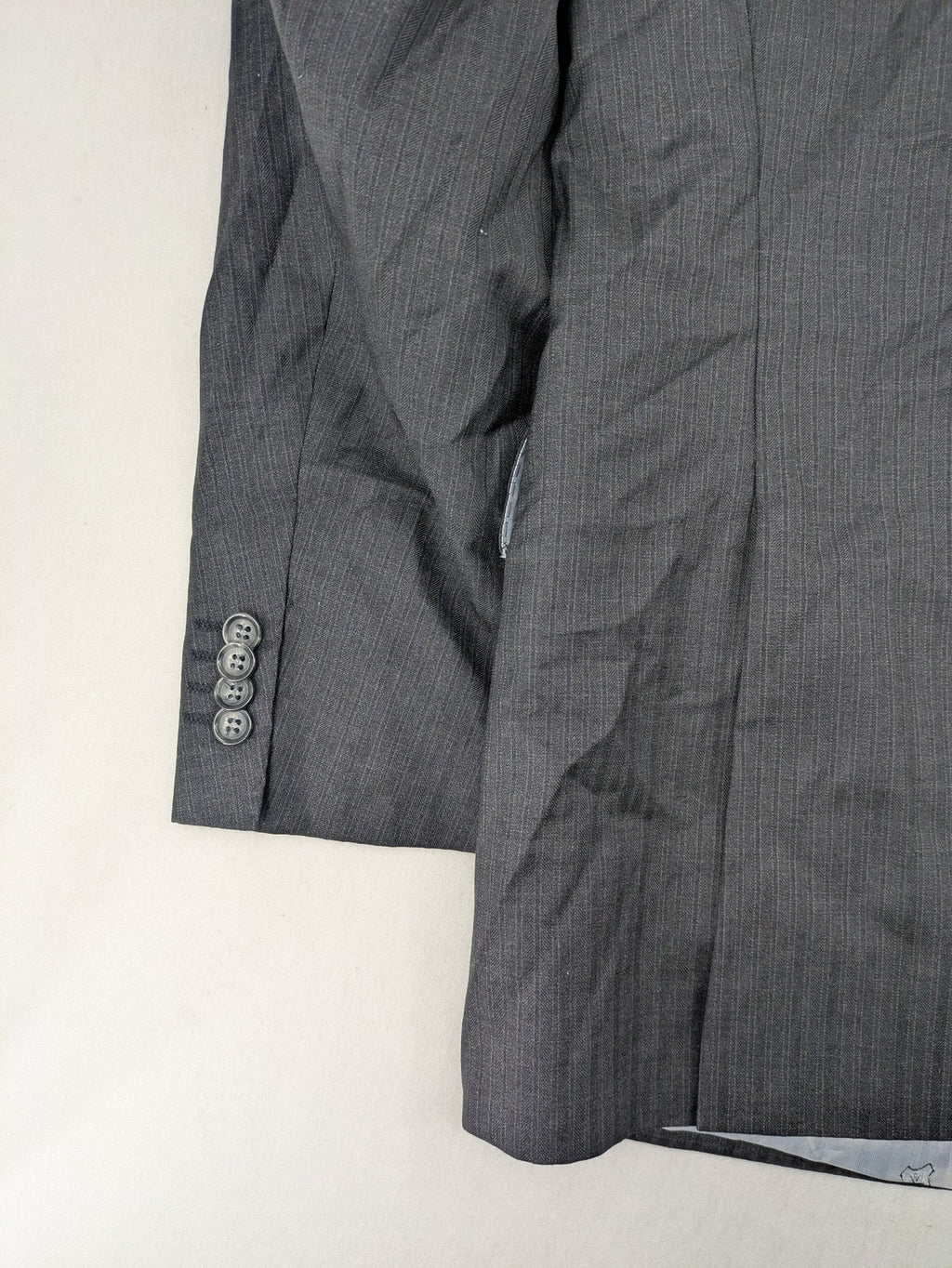 Desch grey blazer with dark grey pinstripe pattern, satin lining, and tailored design.