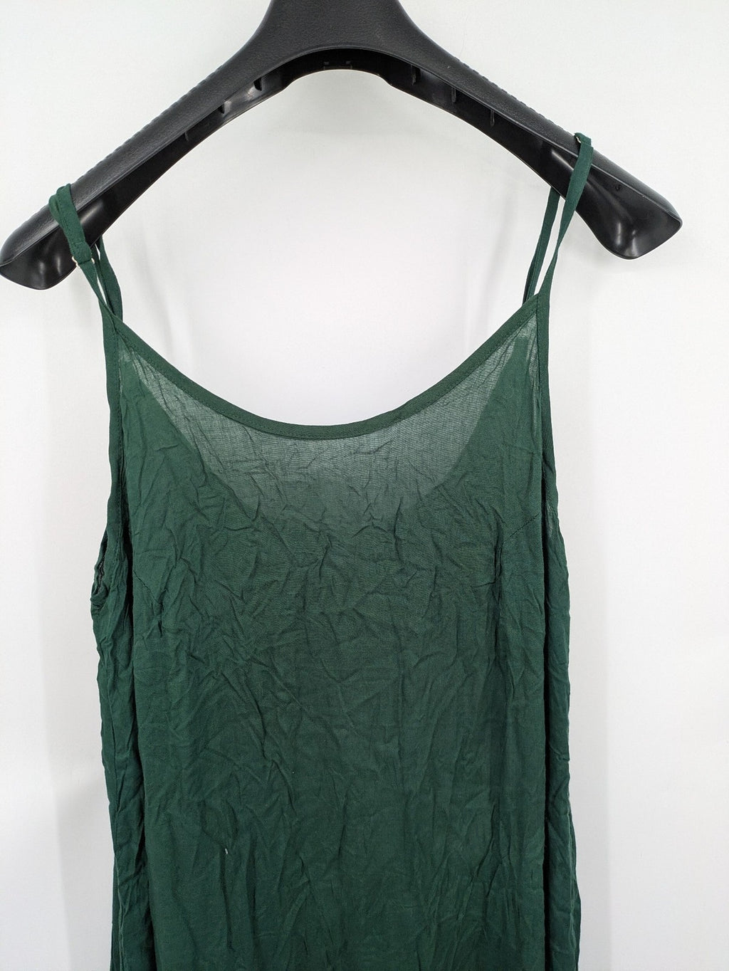 Boho green maxi dress with floral embroidery along tiered hem and adjustable spaghetti straps.