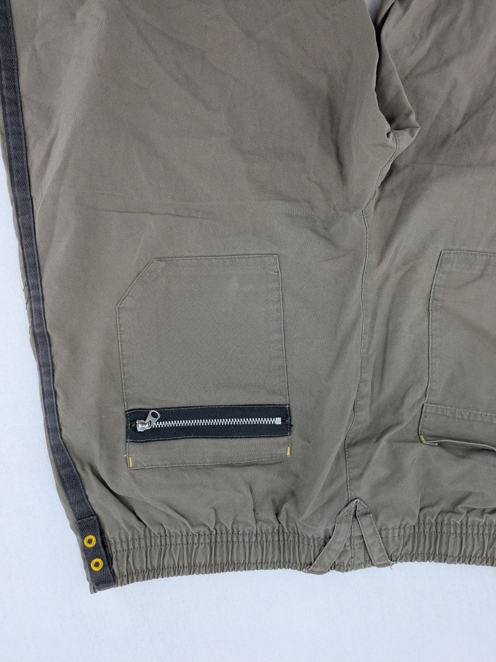 Nike khaki training pants with logo, elastic waistband, and practical pockets.