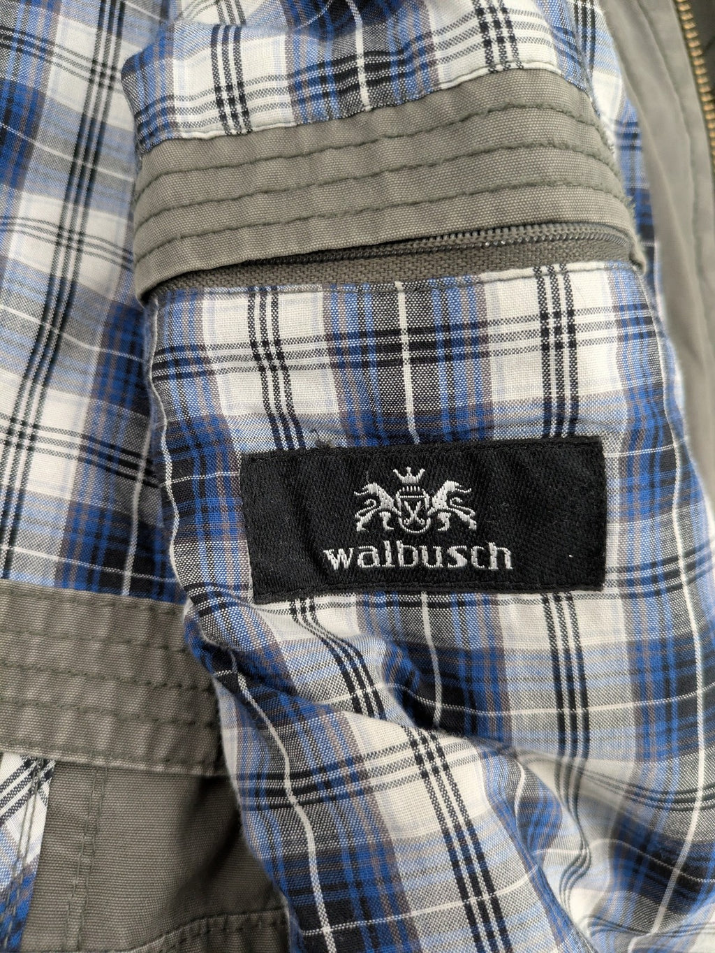 Walbusch khaki military jacket with checkered blue-white lining and multiple pockets.