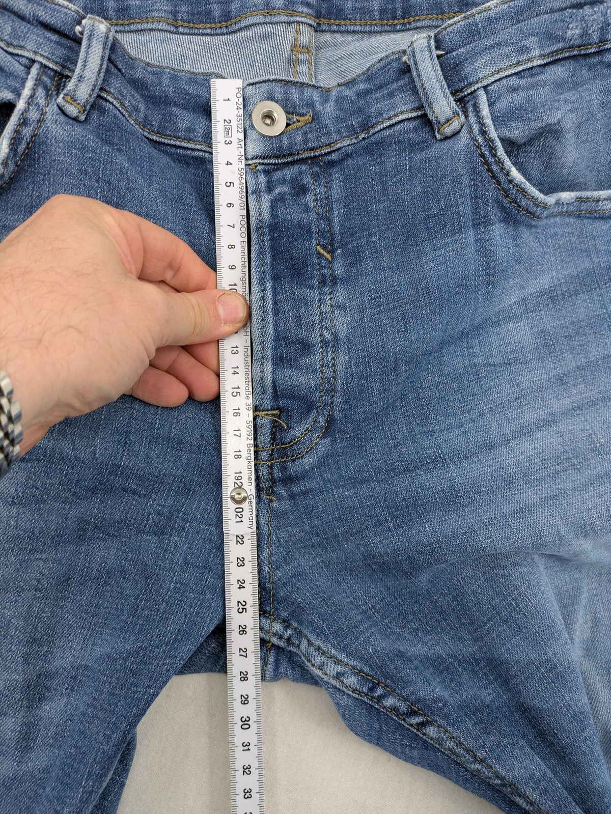Zara blue straight jeans with distressed ripped knees and button-fly closure.