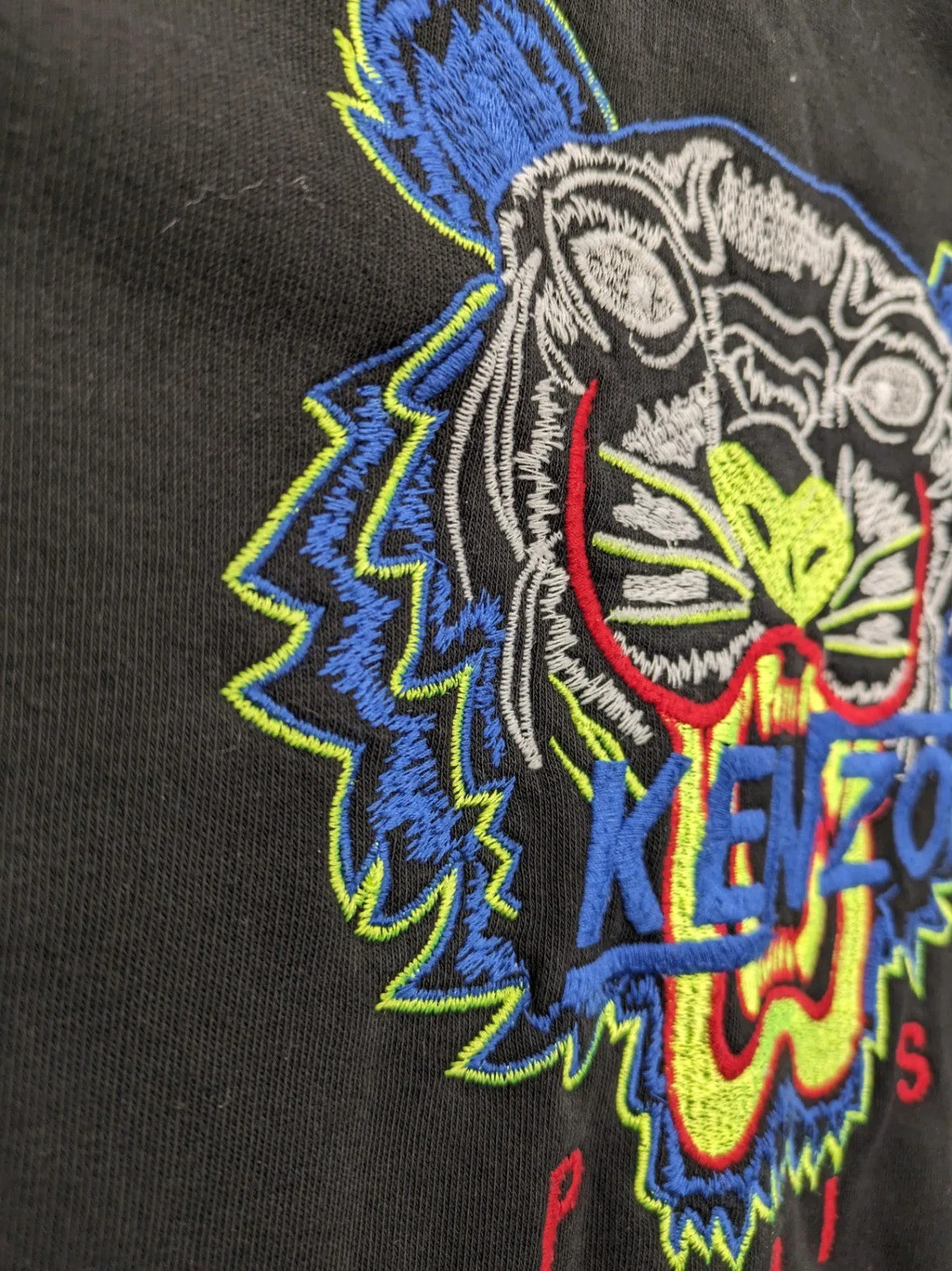 Kenzo multi hoodie with embroidered tiger graphic, drawstring hood, and kangaroo pocket.