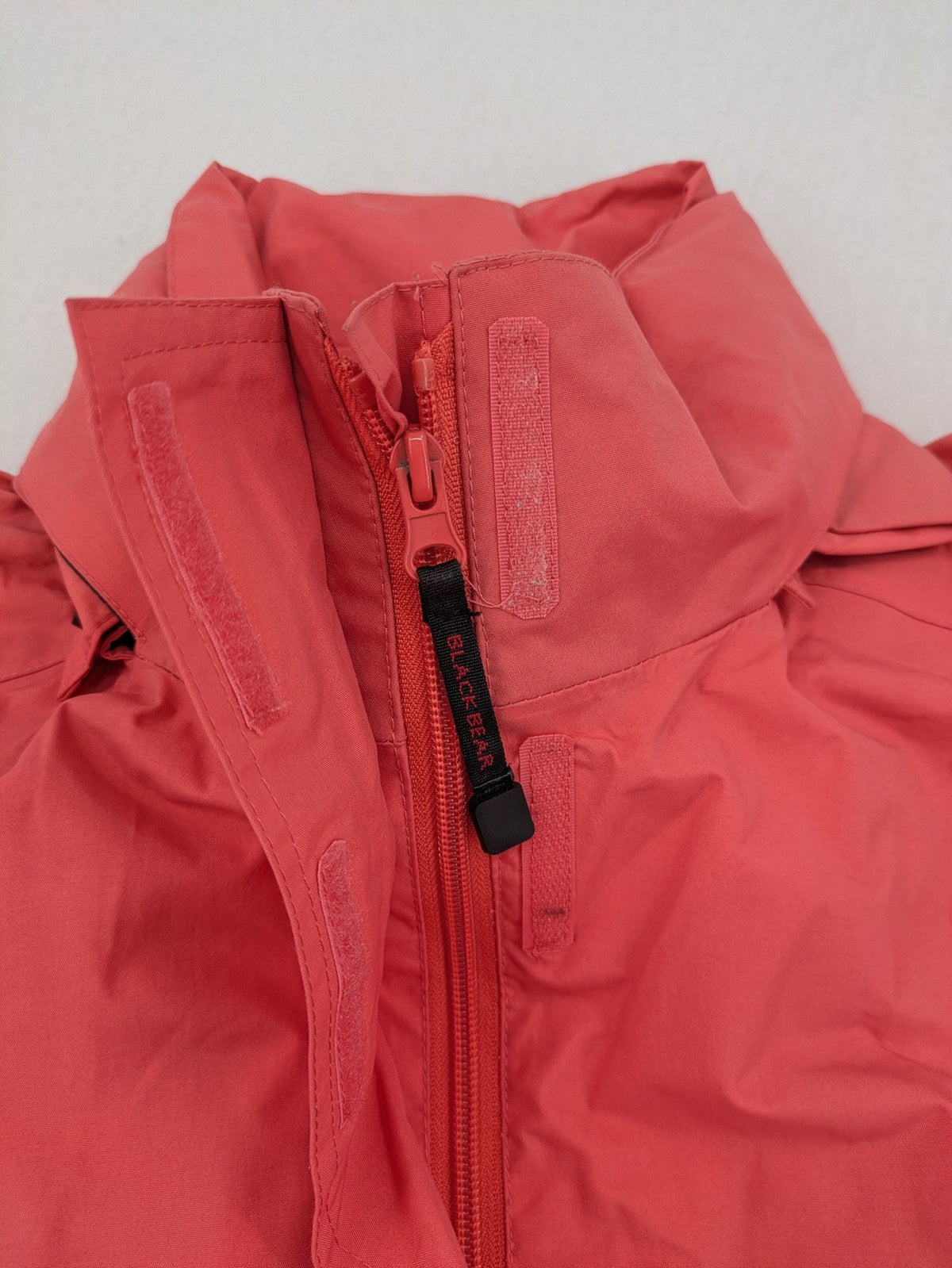 Black Bear black rain jacket with coral pink mesh lining and full zipper.