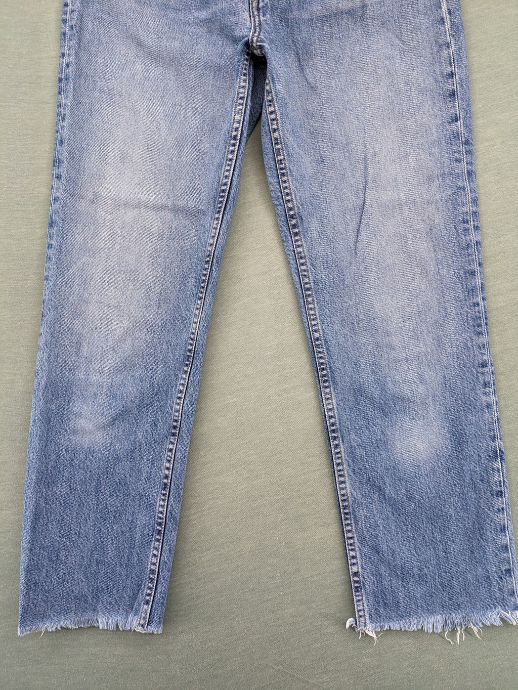Re/Done blue straight jeans high rise with button fly and raw hem detail.