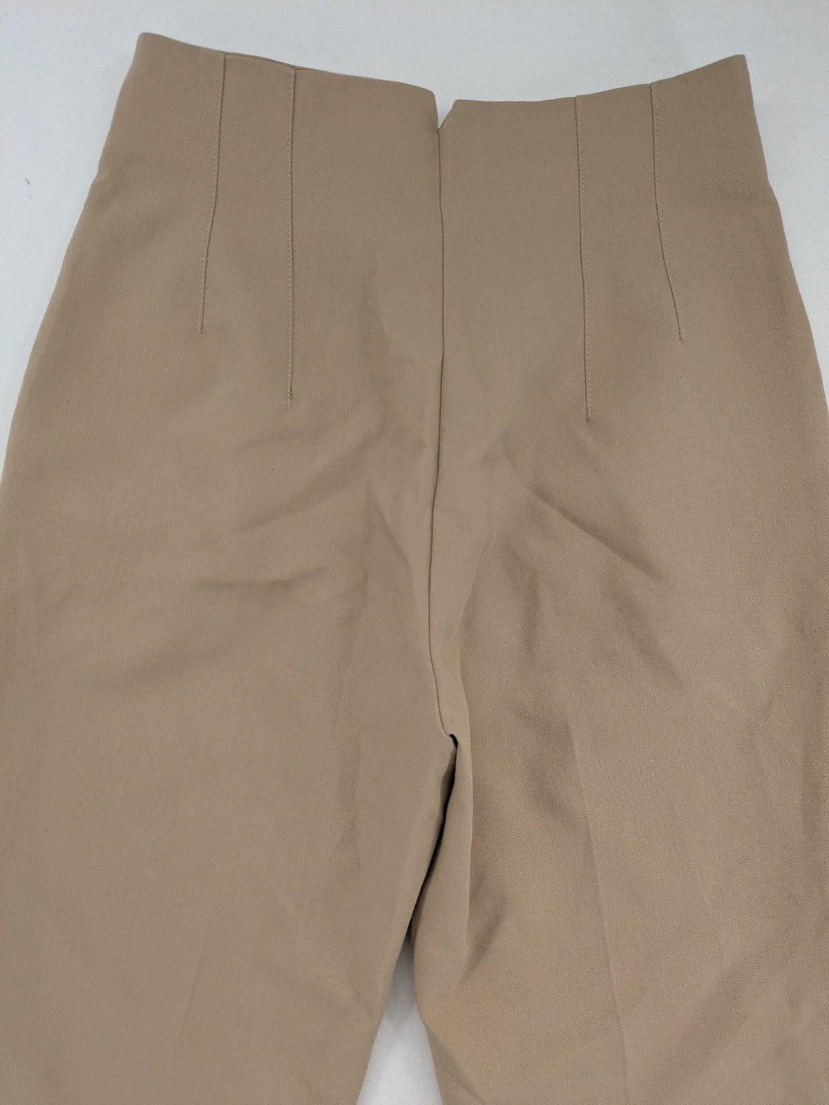 Tapered beige pants high-waist tapered fit with classic front creases and side pockets.