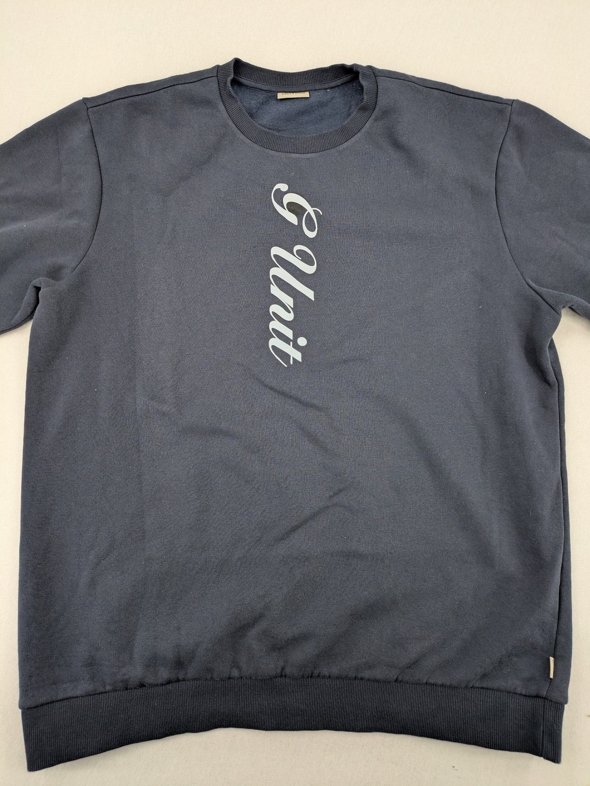 G-Unit navy turtle neck jumper with vertical logo graphic and soft fleece interior.