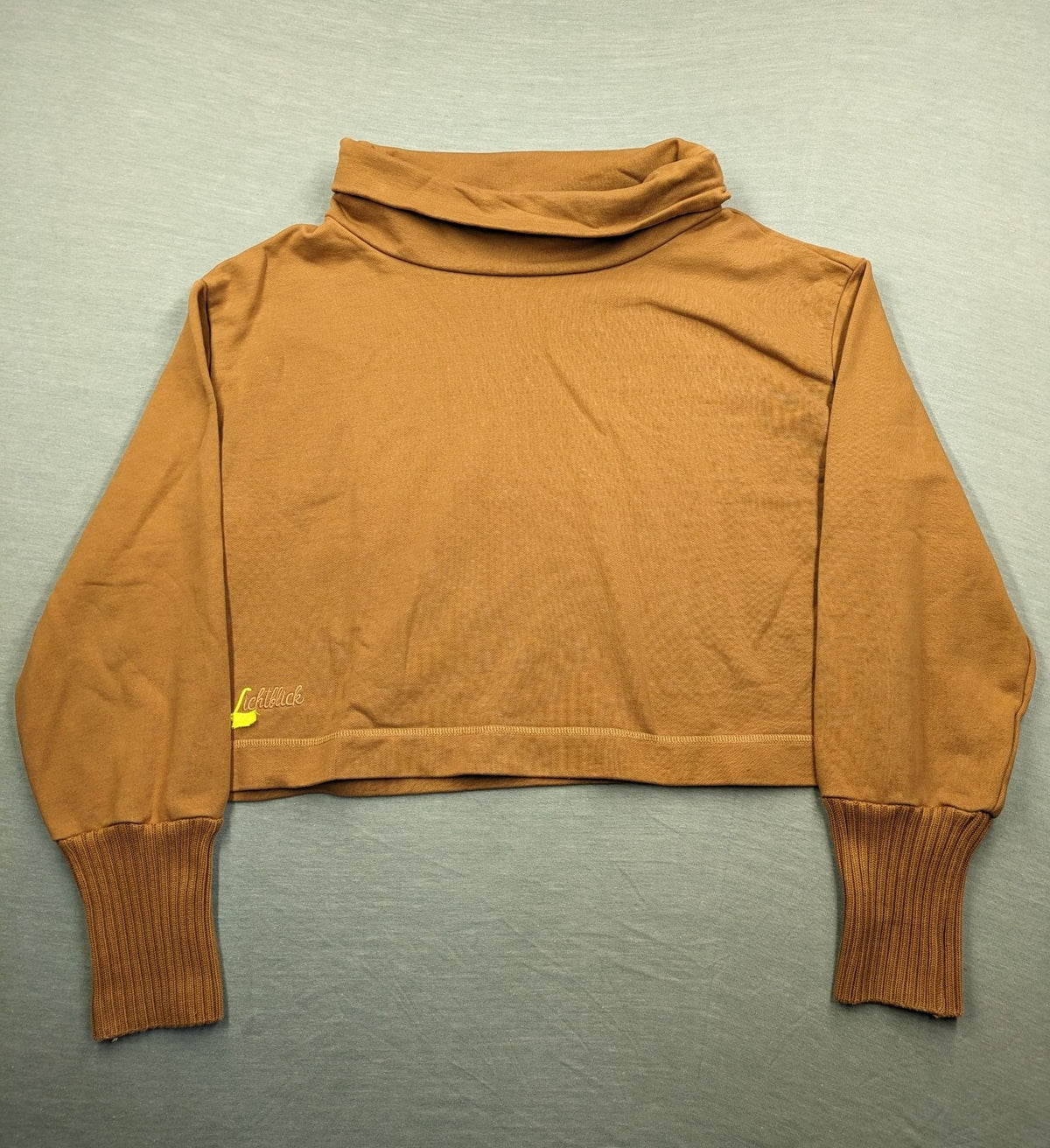 ALS orange crop top sweatshirt with roll neck and embroidered Lichtblick logo.