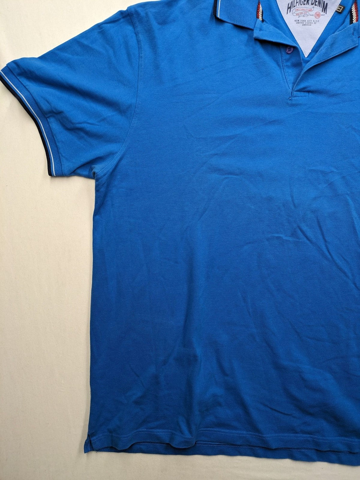Tommy Hilfiger blue polo shirt with white stripes and embroidered logo on chest.