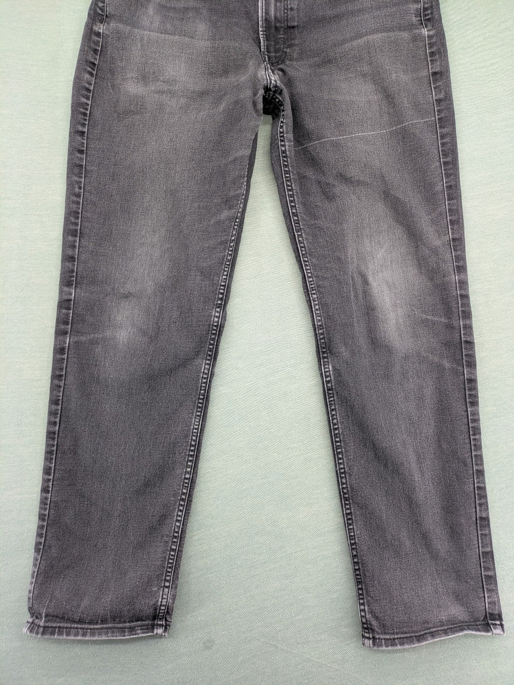 H&M grey slim fit jeans with adjustable waistband and faded wash detail.