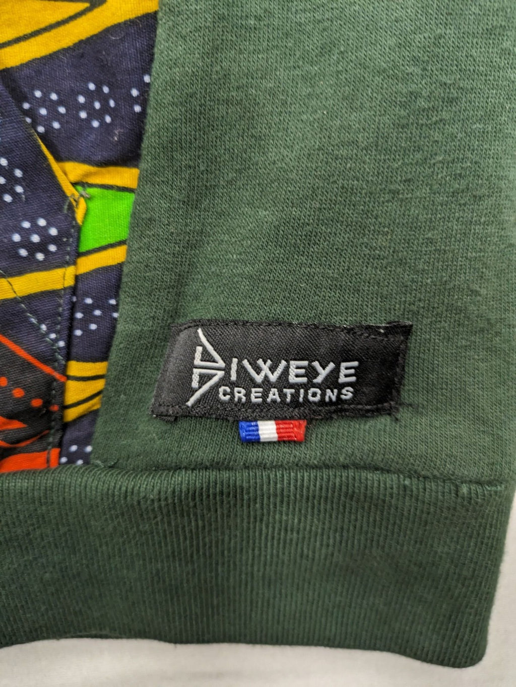 Diweye Creations multi turtle neck jumper with vibrant African print and soft green material.