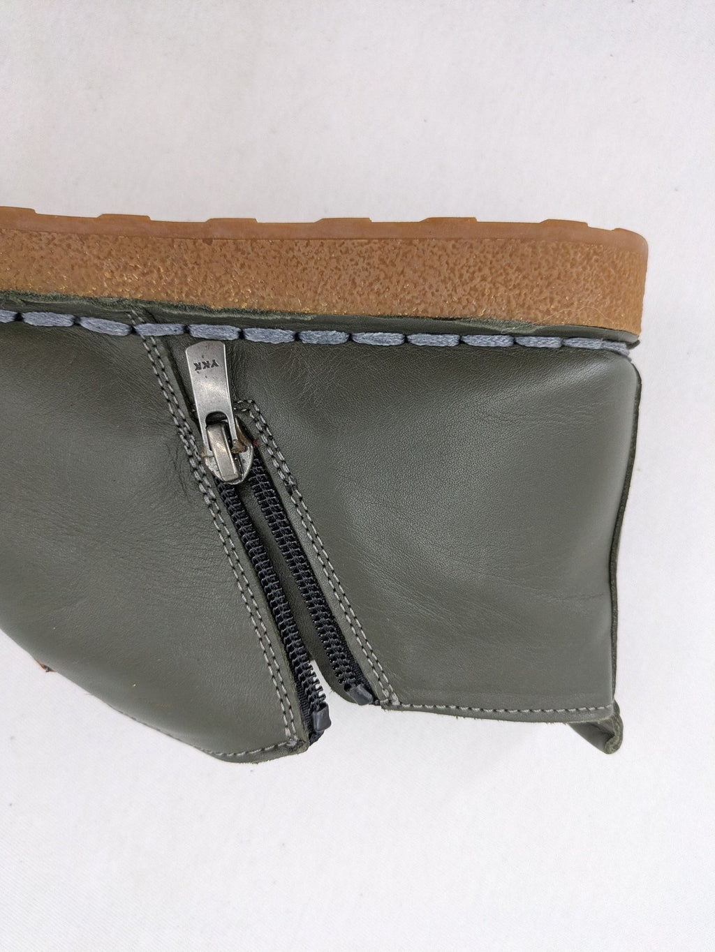 ALS green leather booties with side zipper and decorative stitching.