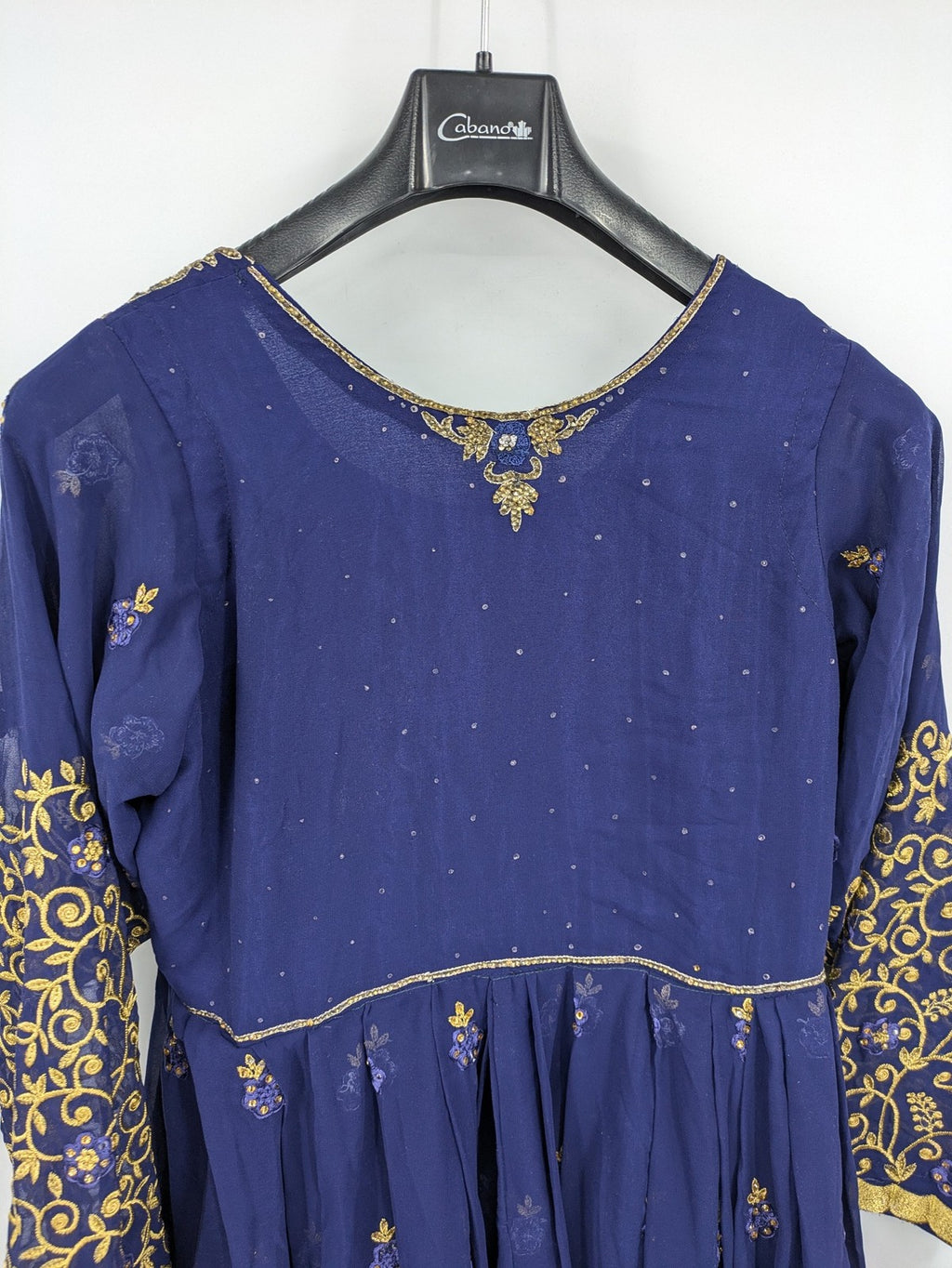 Bollywood bridal party dress gold with intricate blue embroidery and flowing Anarkali silhouette.
