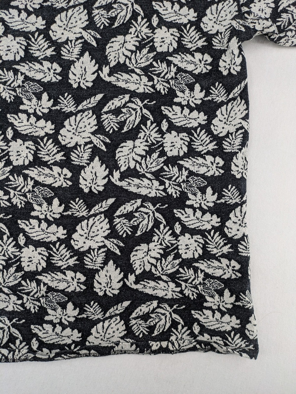 Zara Man black and white t-shirt with allover leaf print and textured knit fabric.