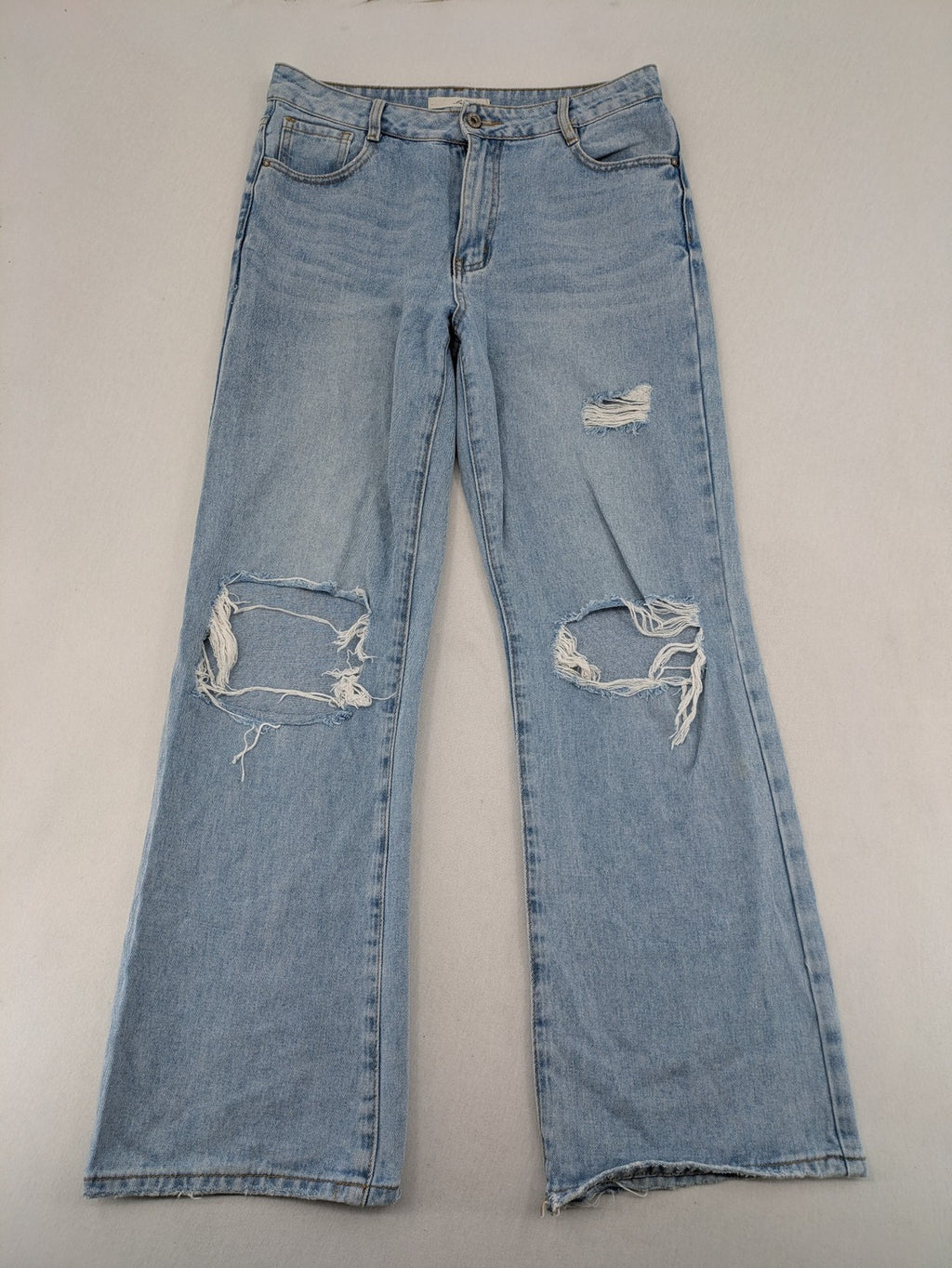 Laulia blue wide leg jeans with distressed knee rips and high waist design.