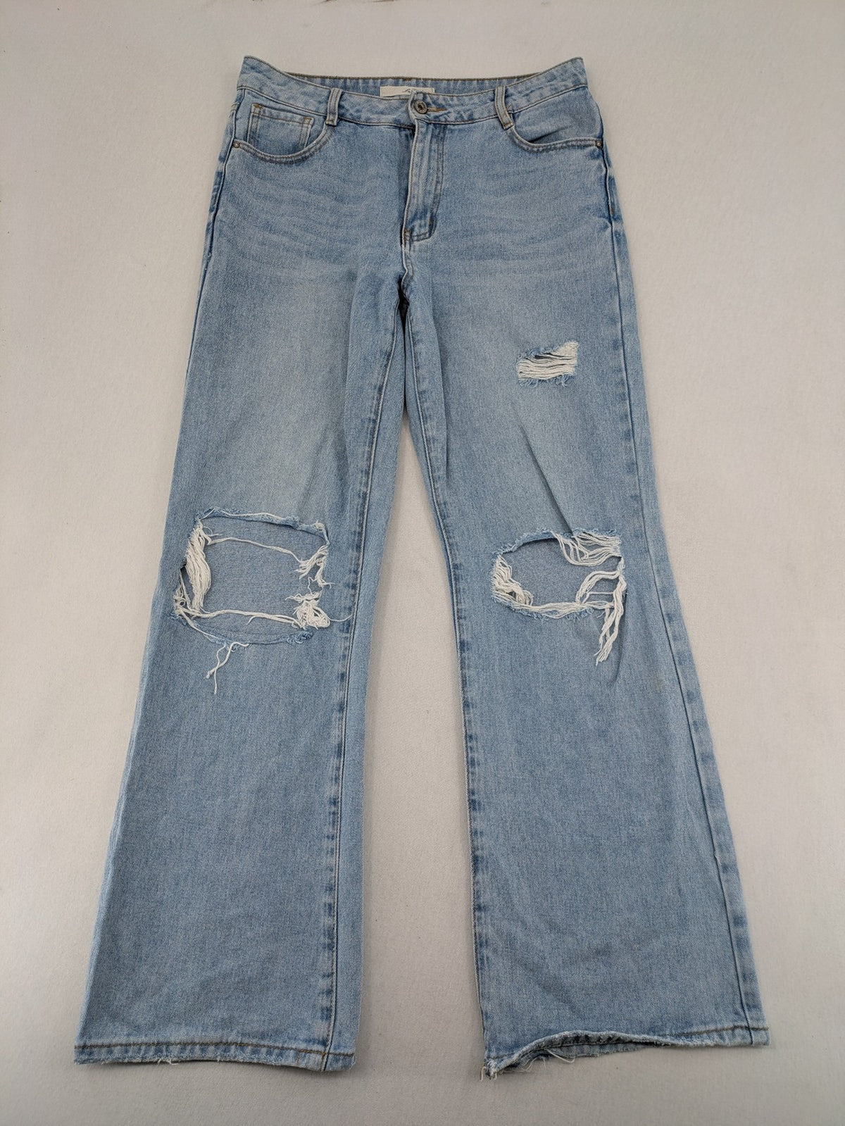 Laulia blue wide leg jeans with distressed knee rips and high waist design.