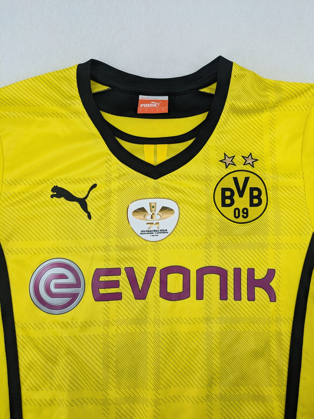 Borussia Dortmund black and yellow soccer uniform with DFB Pokal 2014 patch and Puma logo.