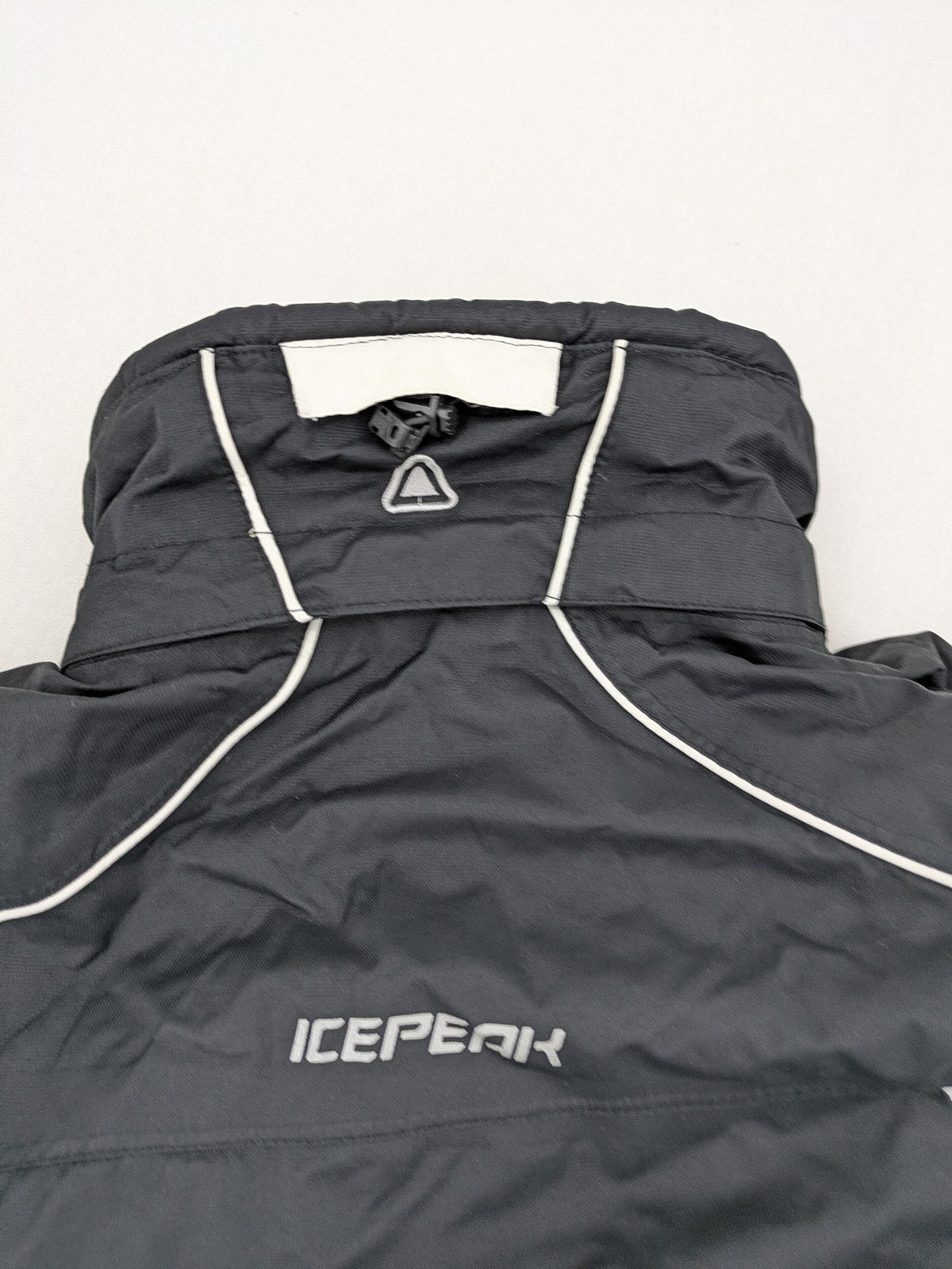 Icepeak black and white ski snowboard jacket with RECCO logo and quilted insulation.