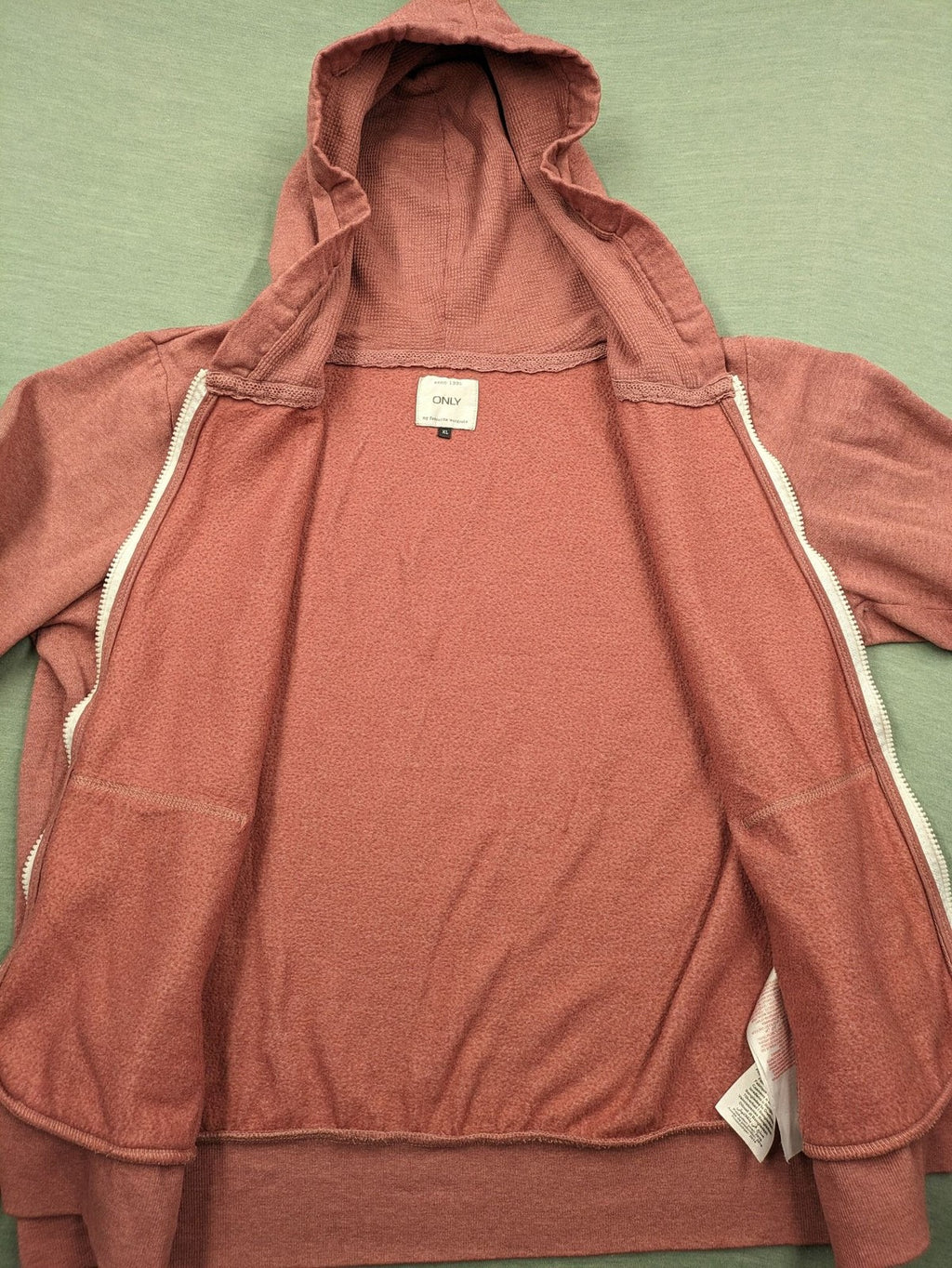 ONLY pink zip-through hoodie with hood, front zipper, and two pockets.