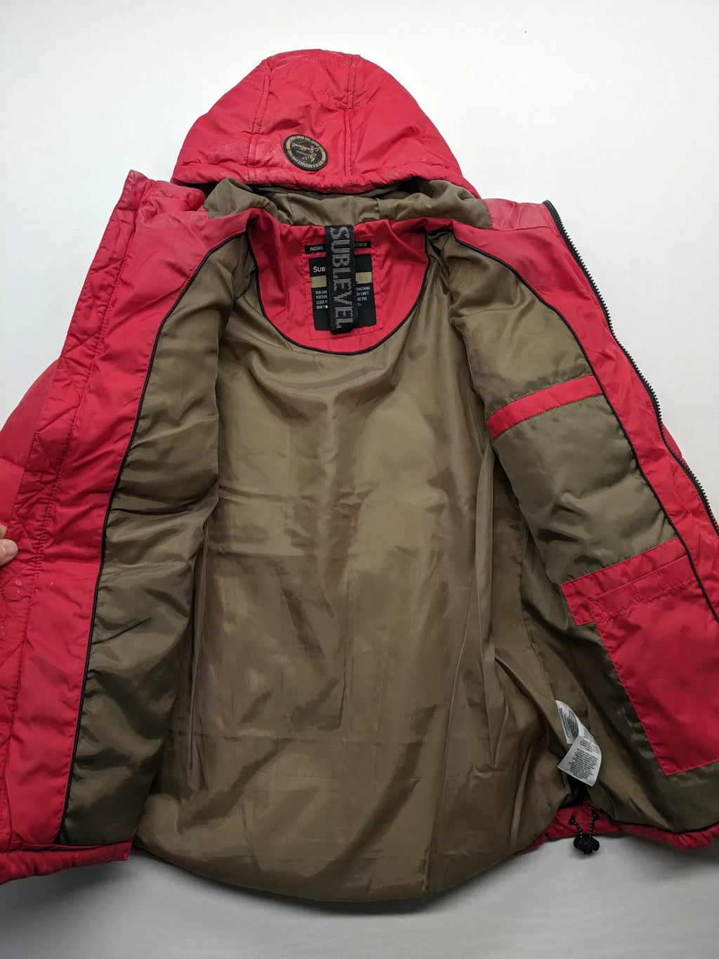 Sublevel red puffer jacket size S, chevron quilted pattern, adjustable hood, recycled polyester lining.