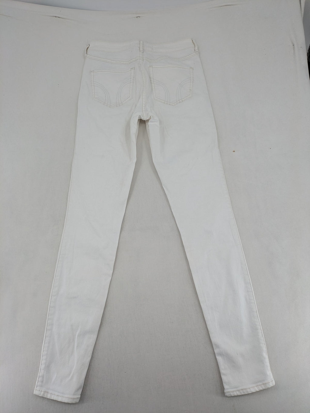 Hollister white super skinny high rise jeans with classic 5-pocket design and zipper closure.