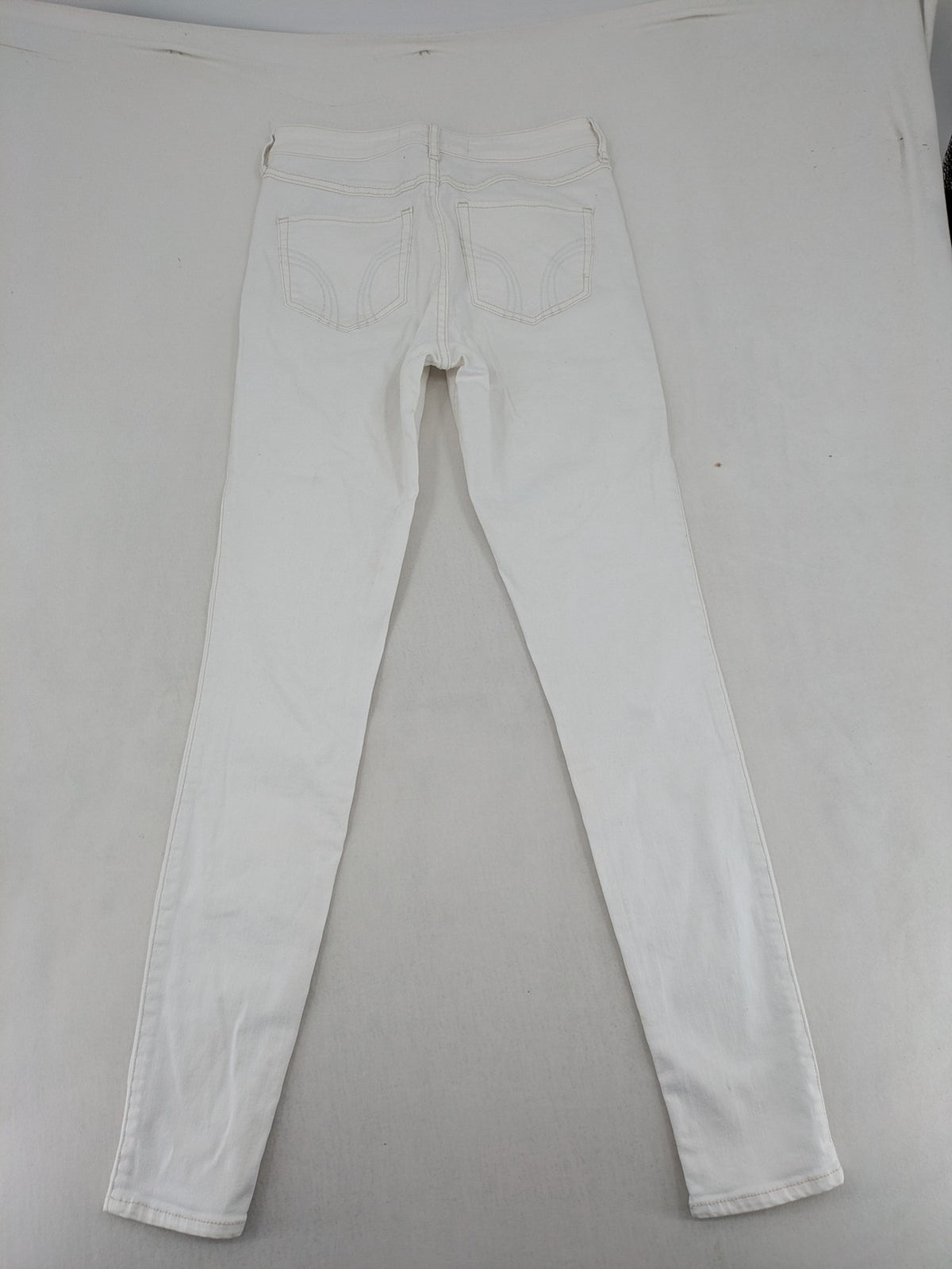 Hollister white super skinny high rise jeans with classic 5-pocket design and zipper closure.