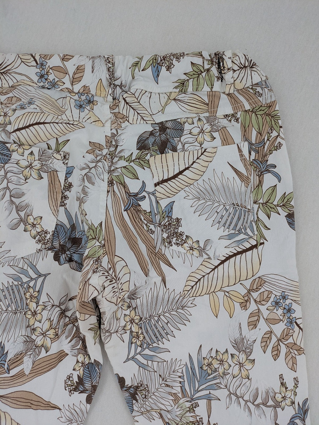 Made in Italy multi pants tropical floral pattern cotton-viscose blend on white background.
