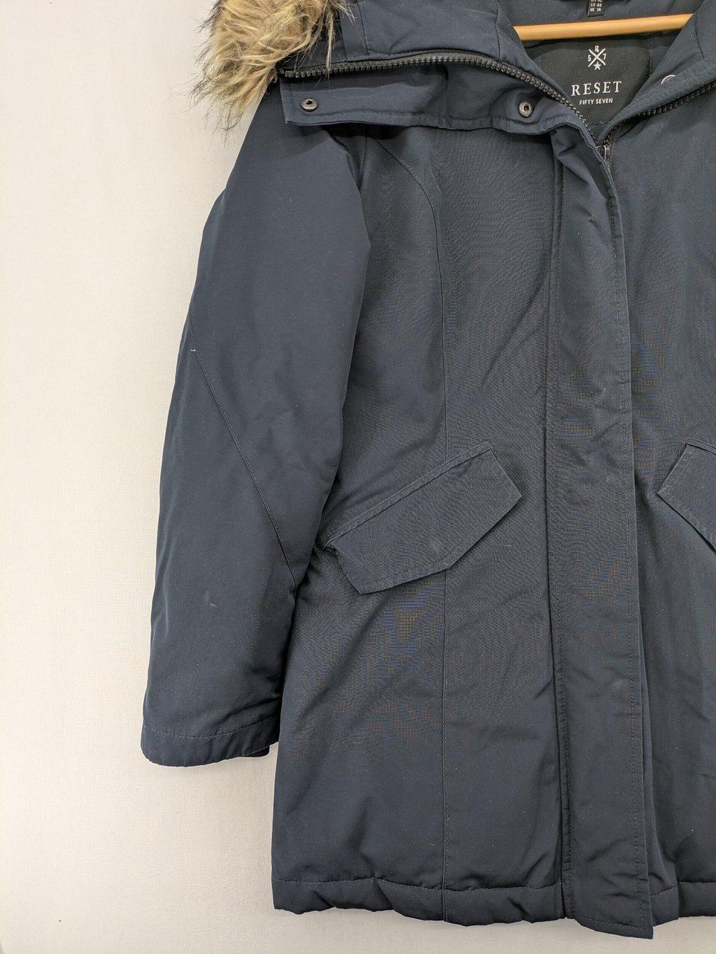 Reset Fifty Seven cream puffer coat with faux fur hood and down insulation.