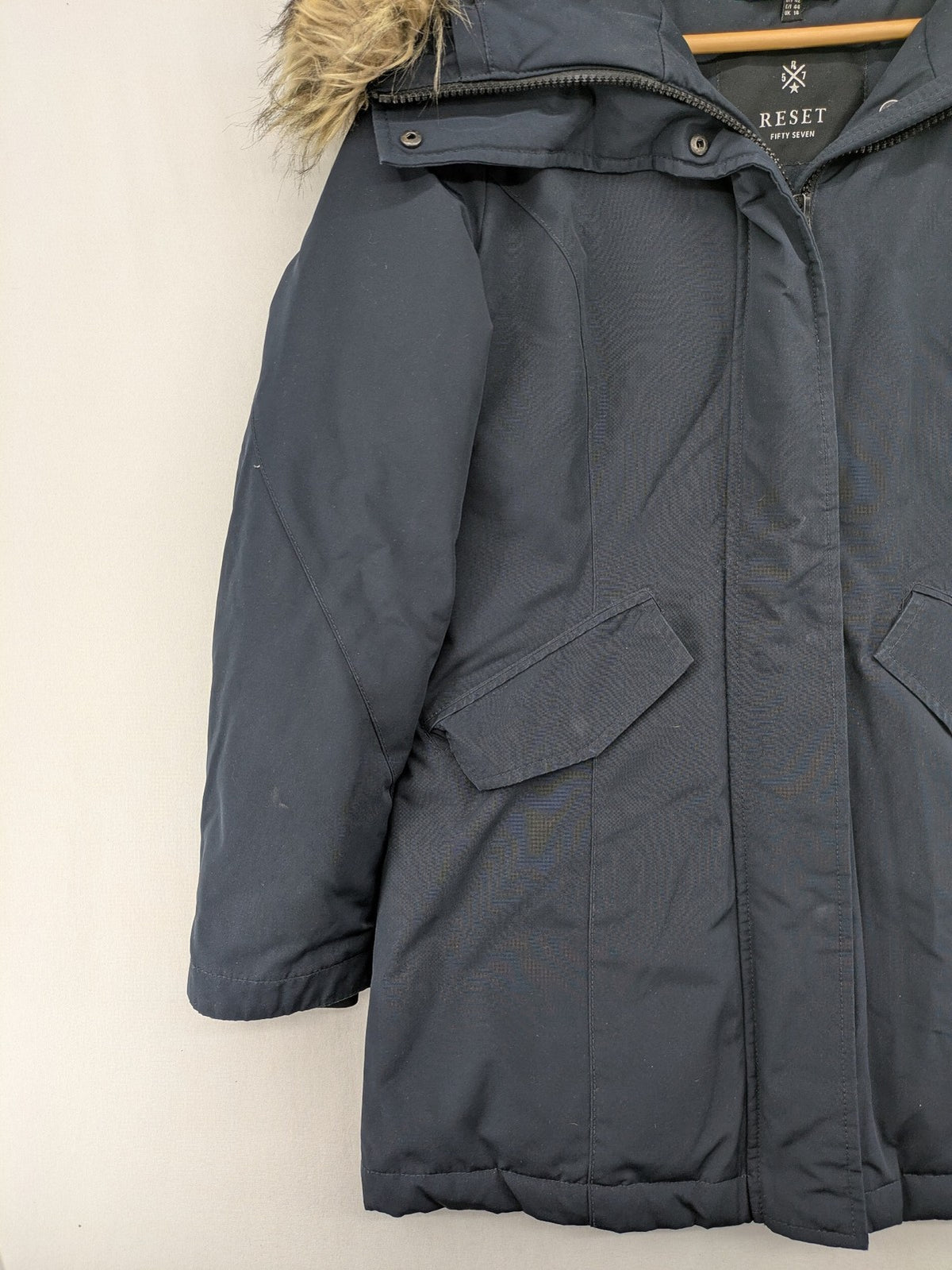 Reset Fifty Seven cream puffer coat with faux fur hood and down insulation.