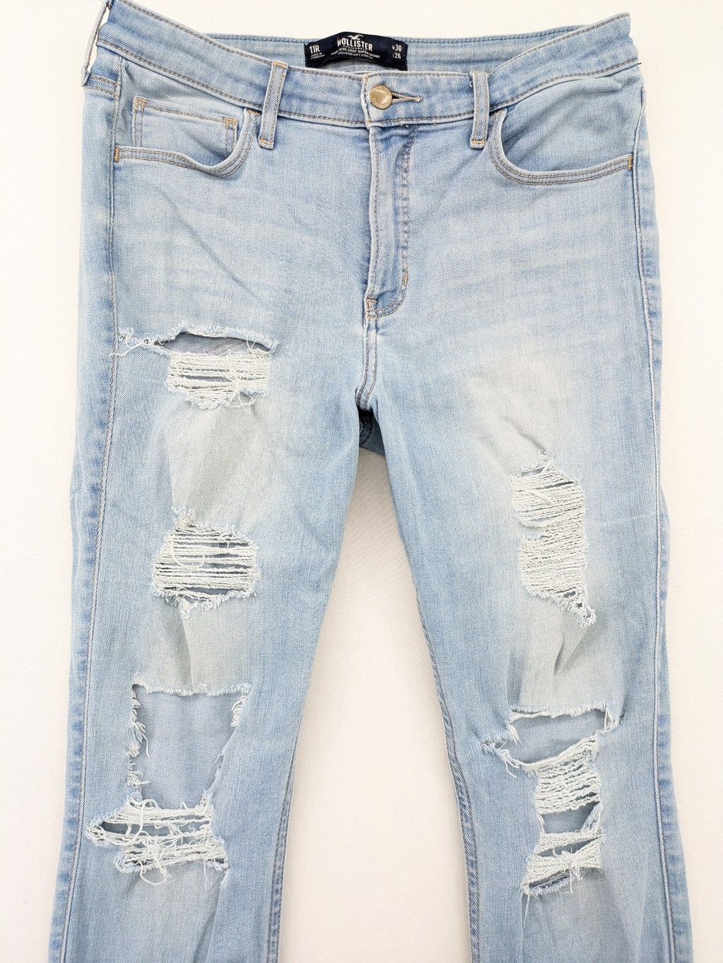 Hollister blue high-rise crop super skinny jeans with distressed rips and frayed hem.